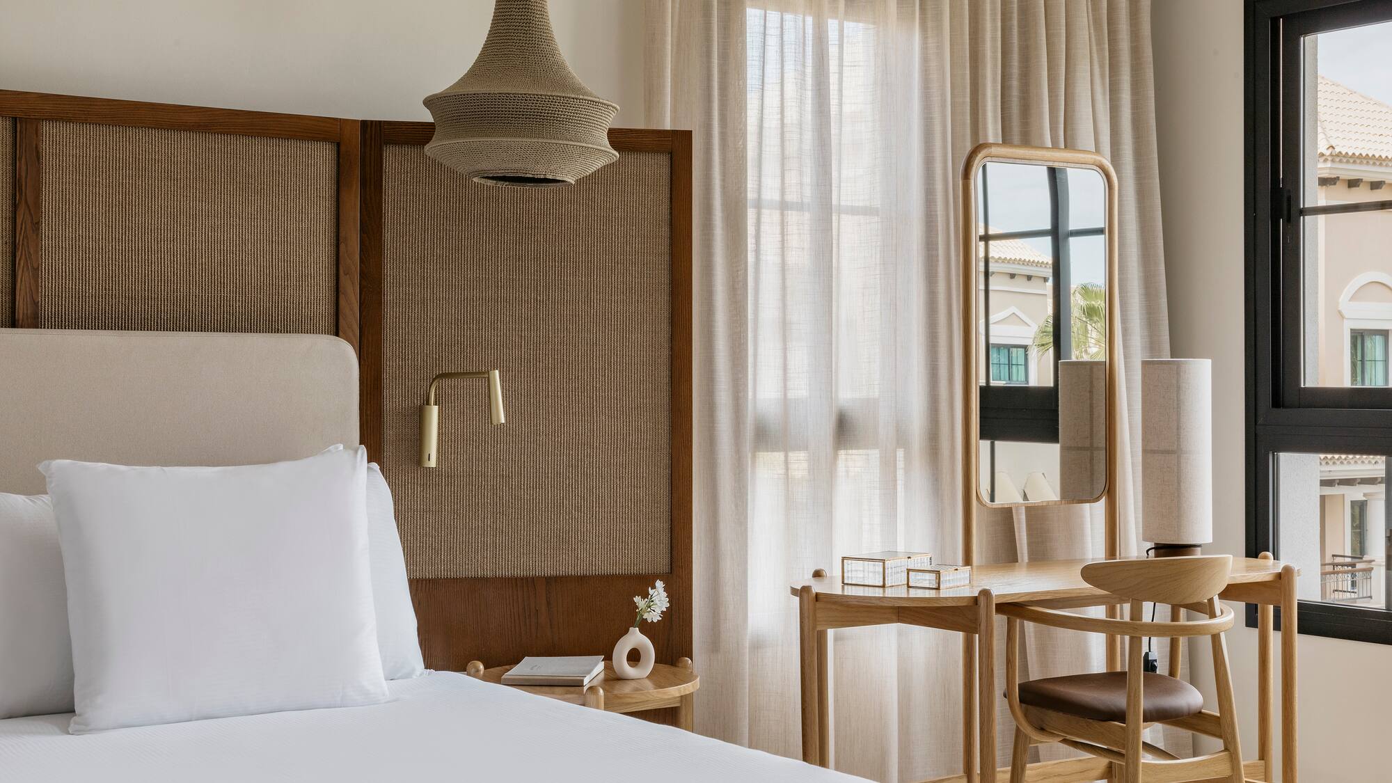 a bedroom with a bed and a mirror