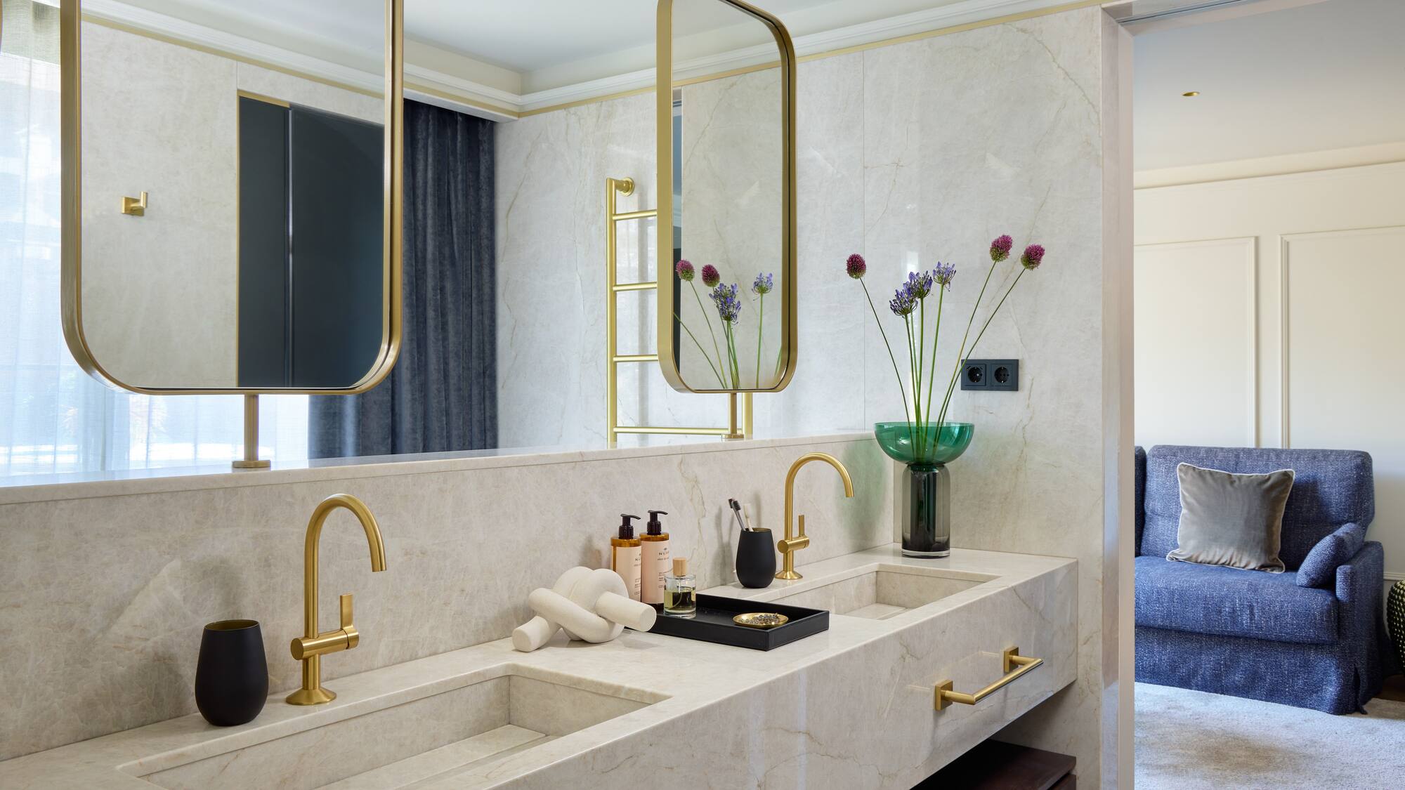 a bathroom with a marble countertop and a mirror