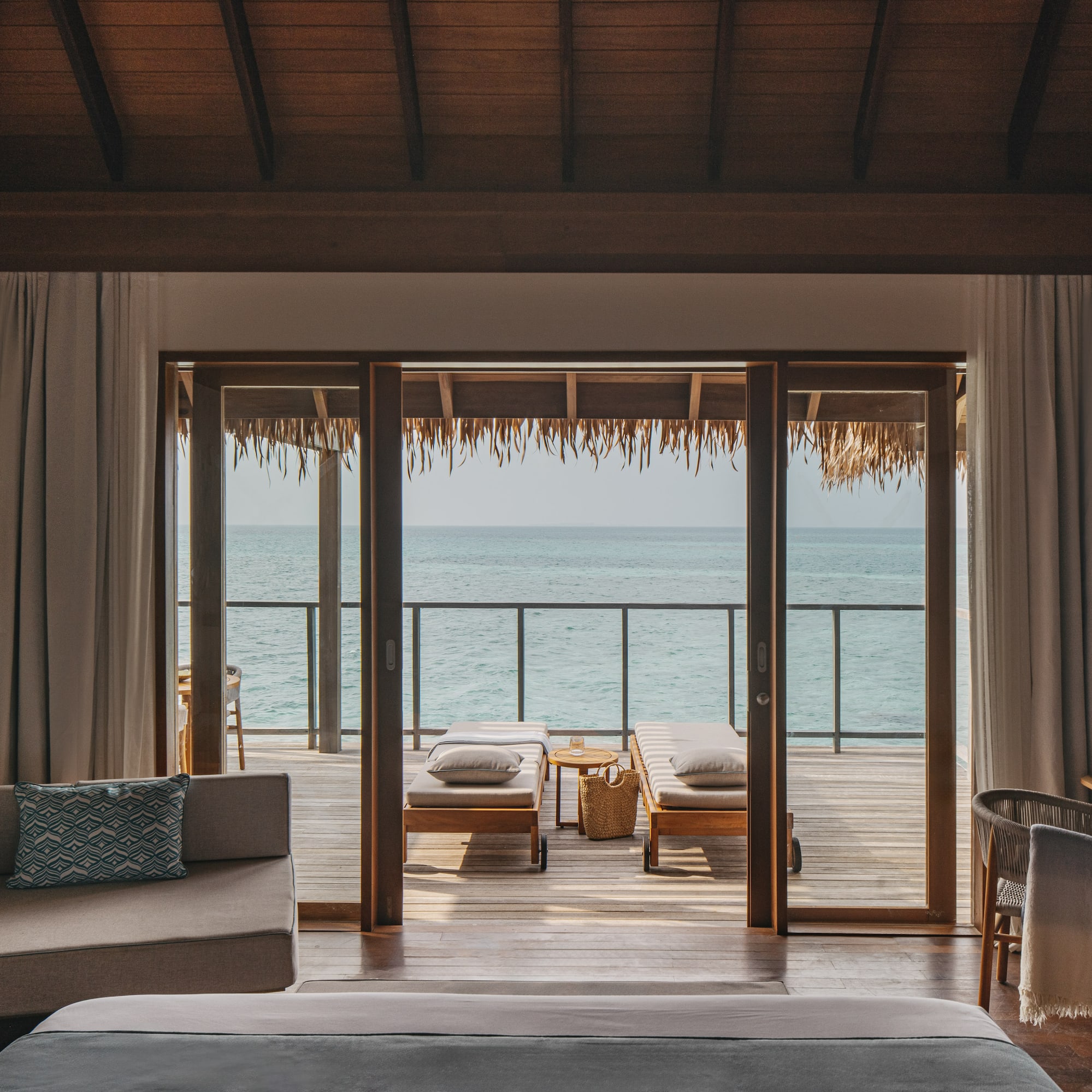 a room with a view of the ocean from the deck