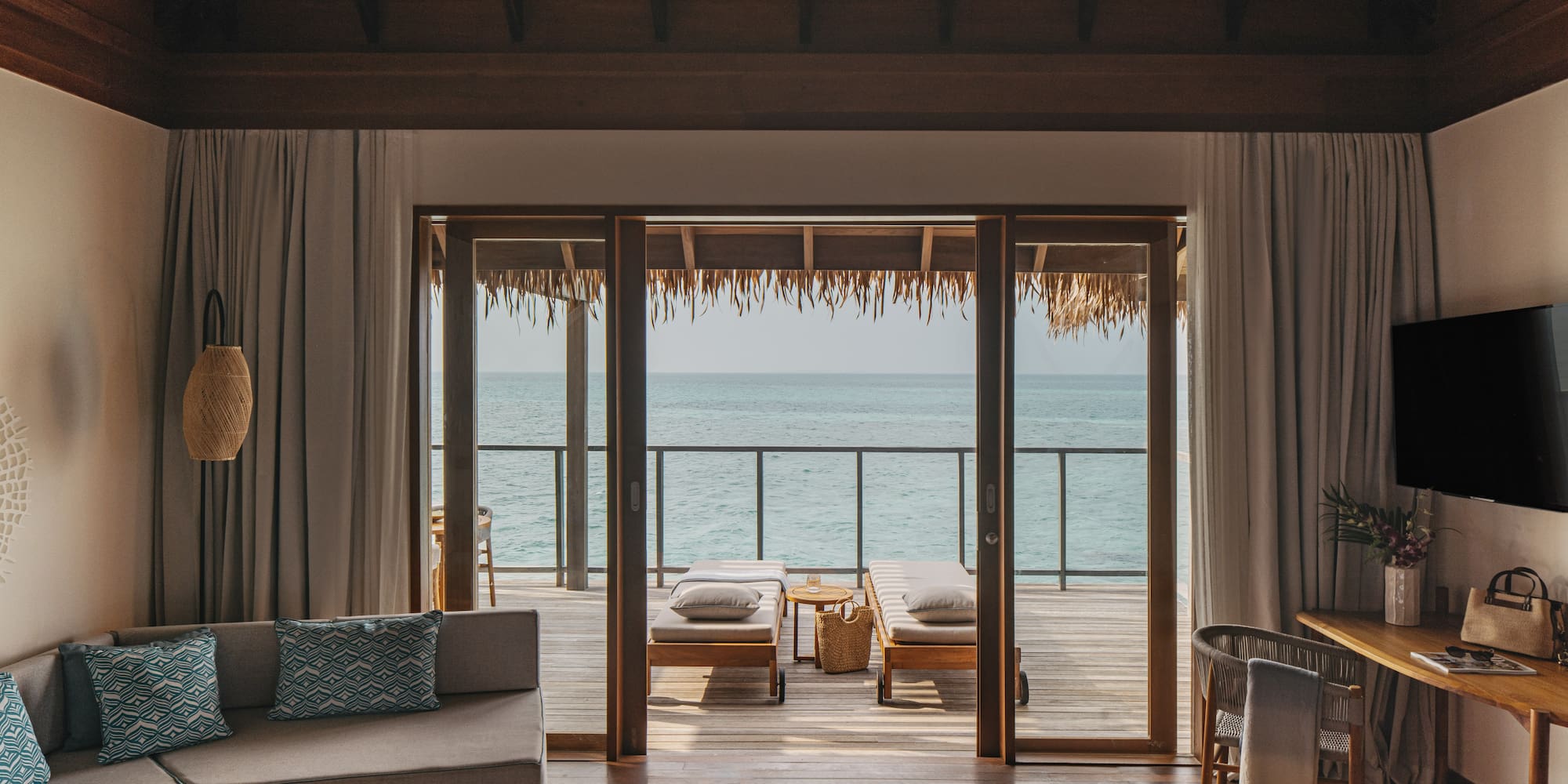 a room with a view of the ocean from the deck