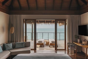 a room with a view of the ocean from the deck