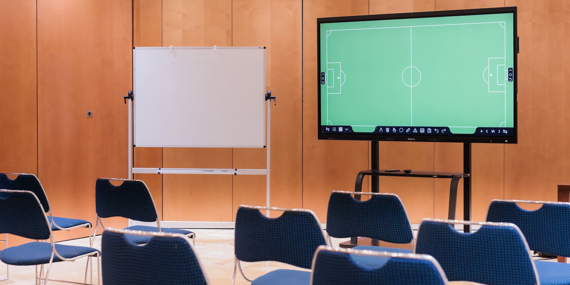 a room with a screen and chairs