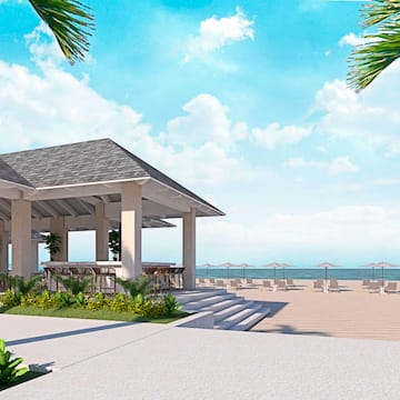 a beach with a gazebo and chairs