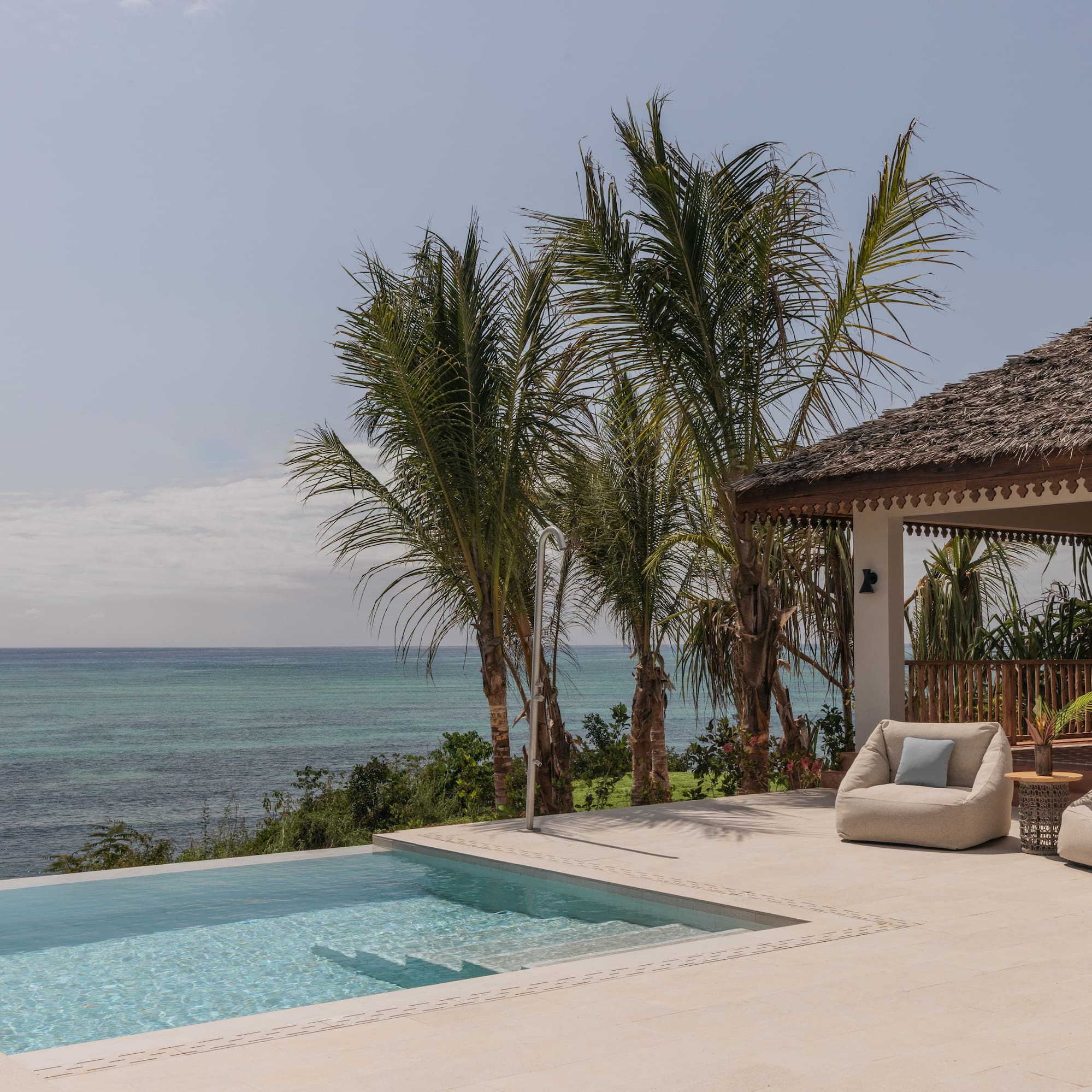 a swimming pool with a deck and chairs by it