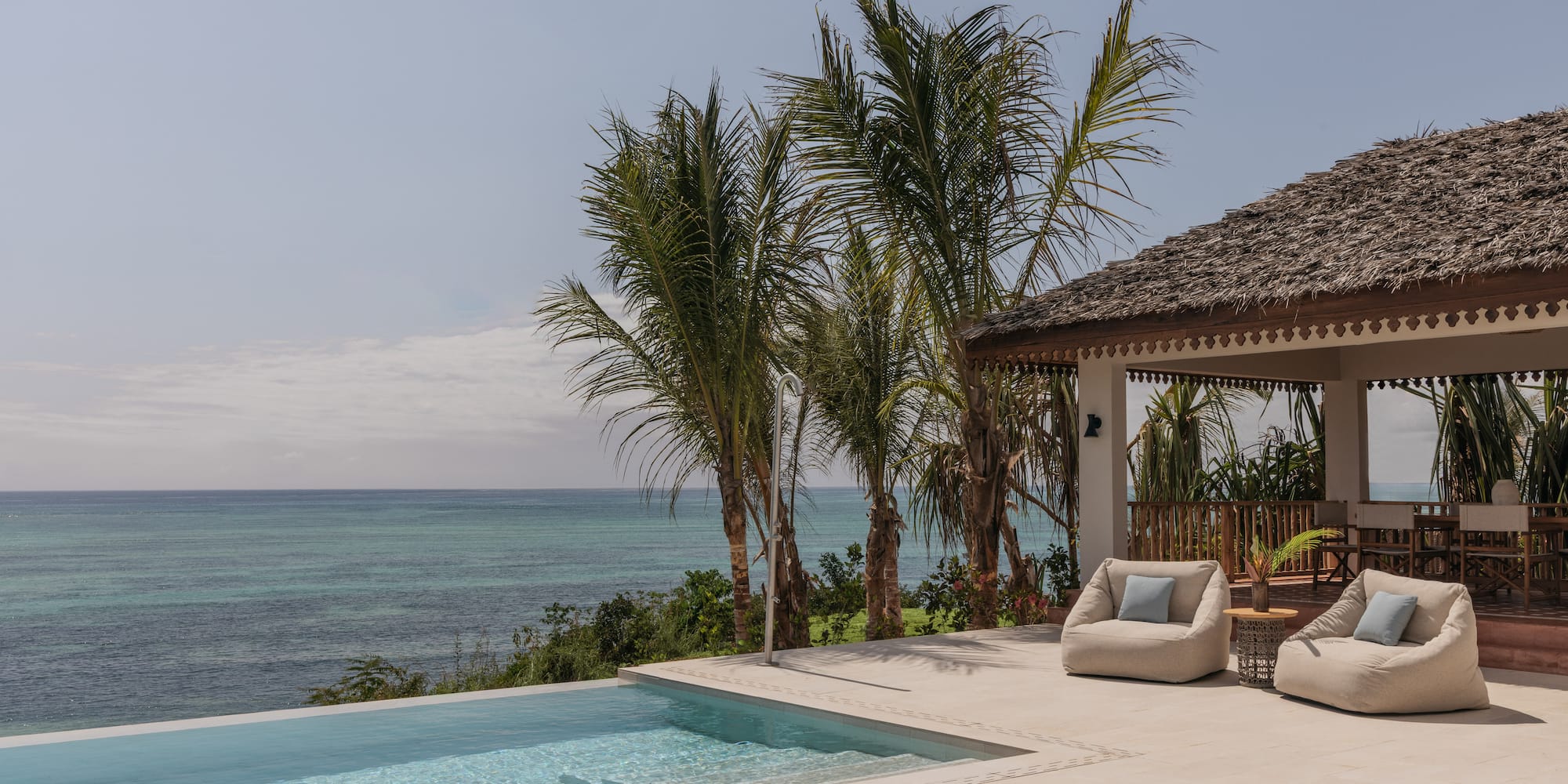 a swimming pool with a deck and chairs by it