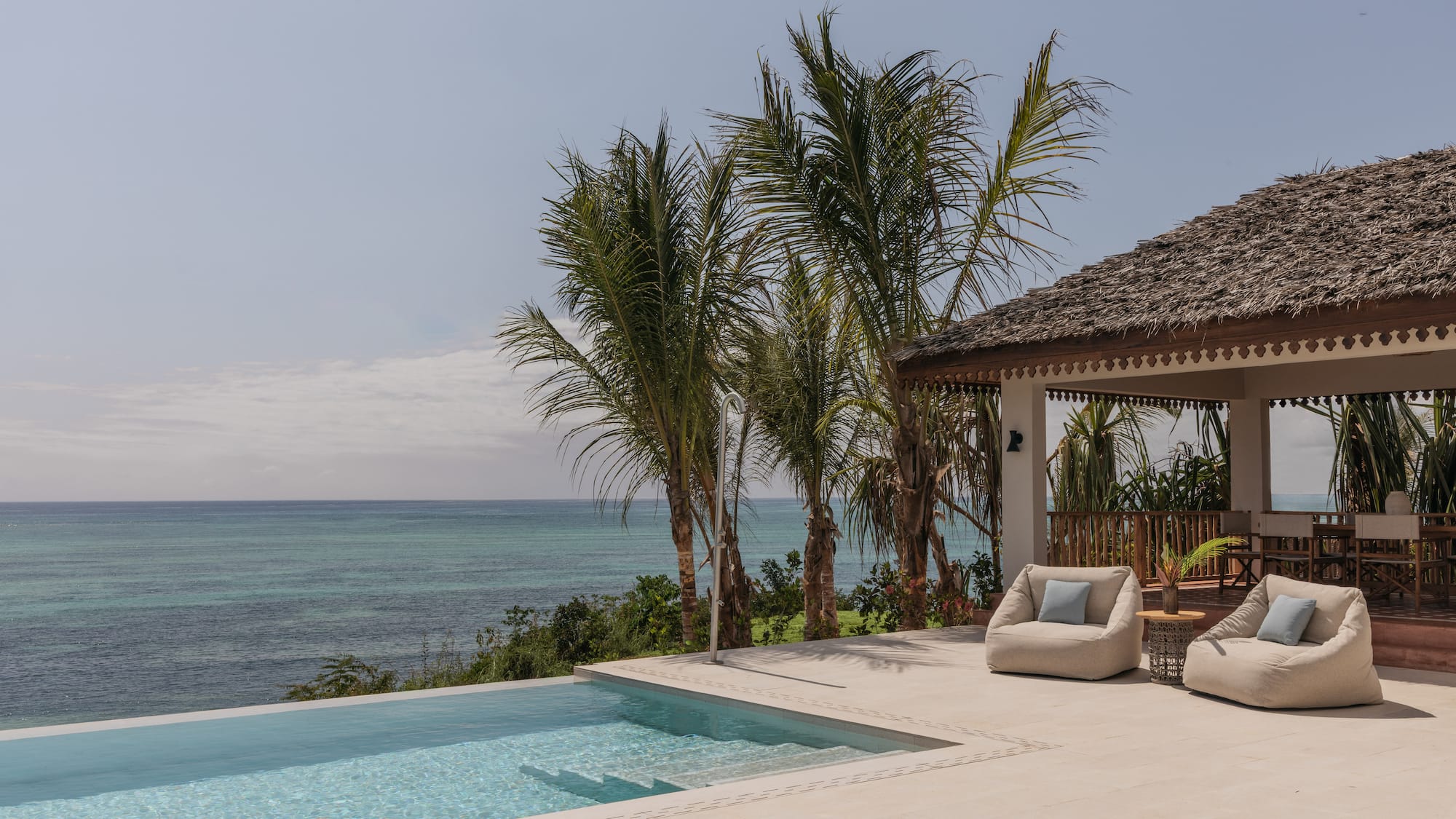a swimming pool with a deck and chairs by it