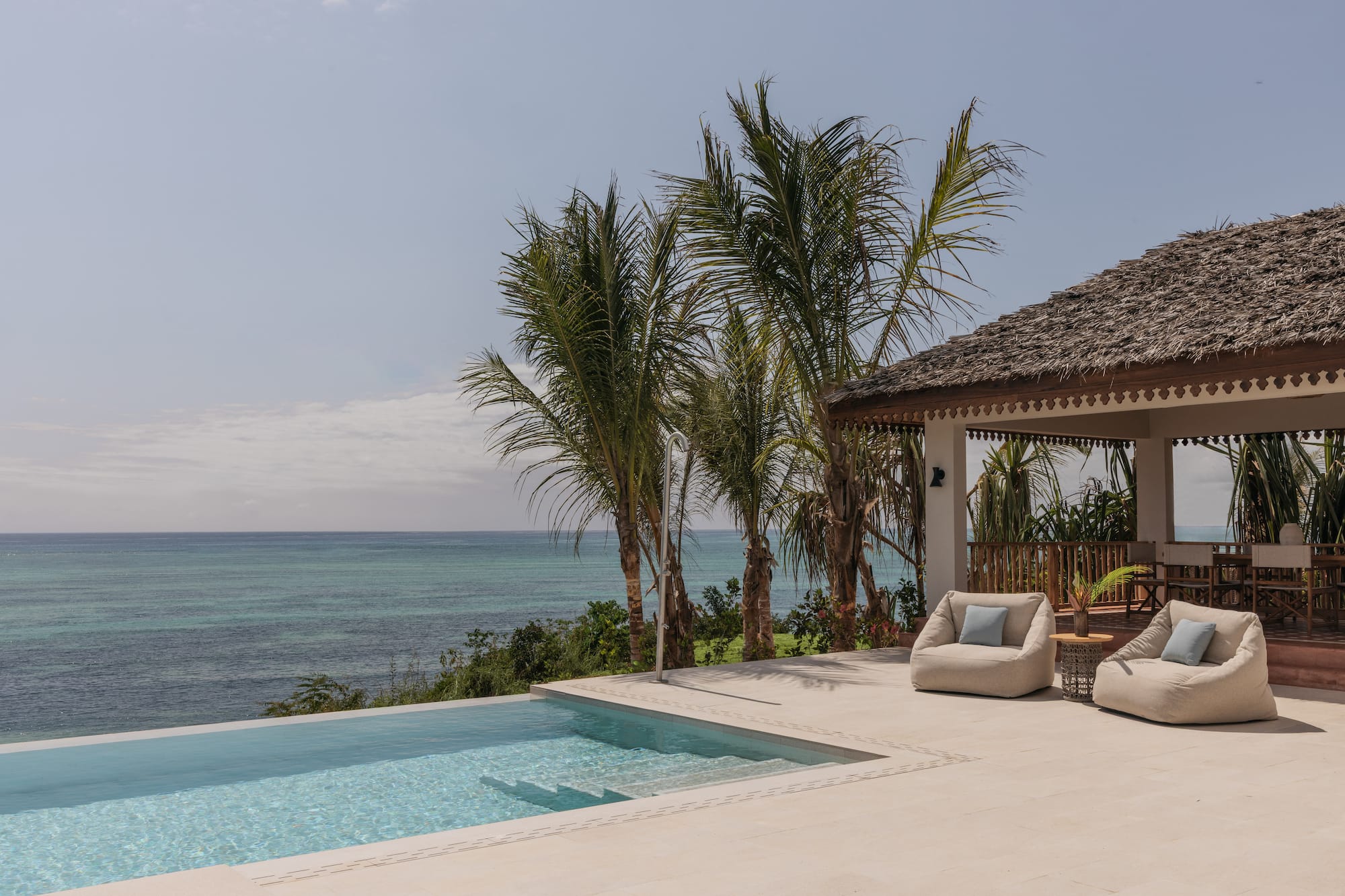 a swimming pool with a deck and chairs by it