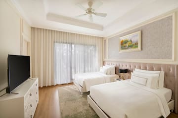 a room with two beds and a tv