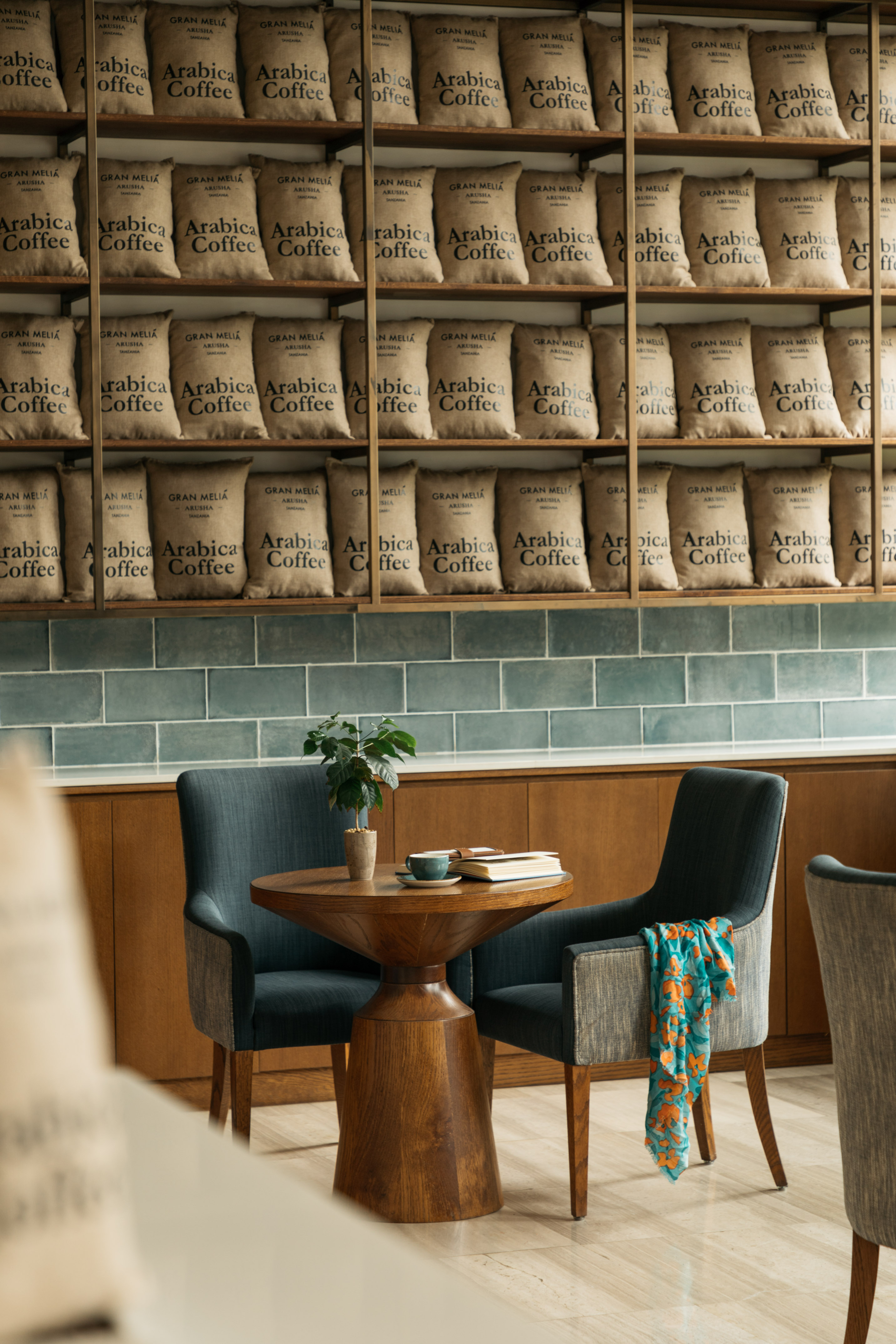 Gran Melia Arusha cafe interior with Arabica coffee bags and cozy seating area.