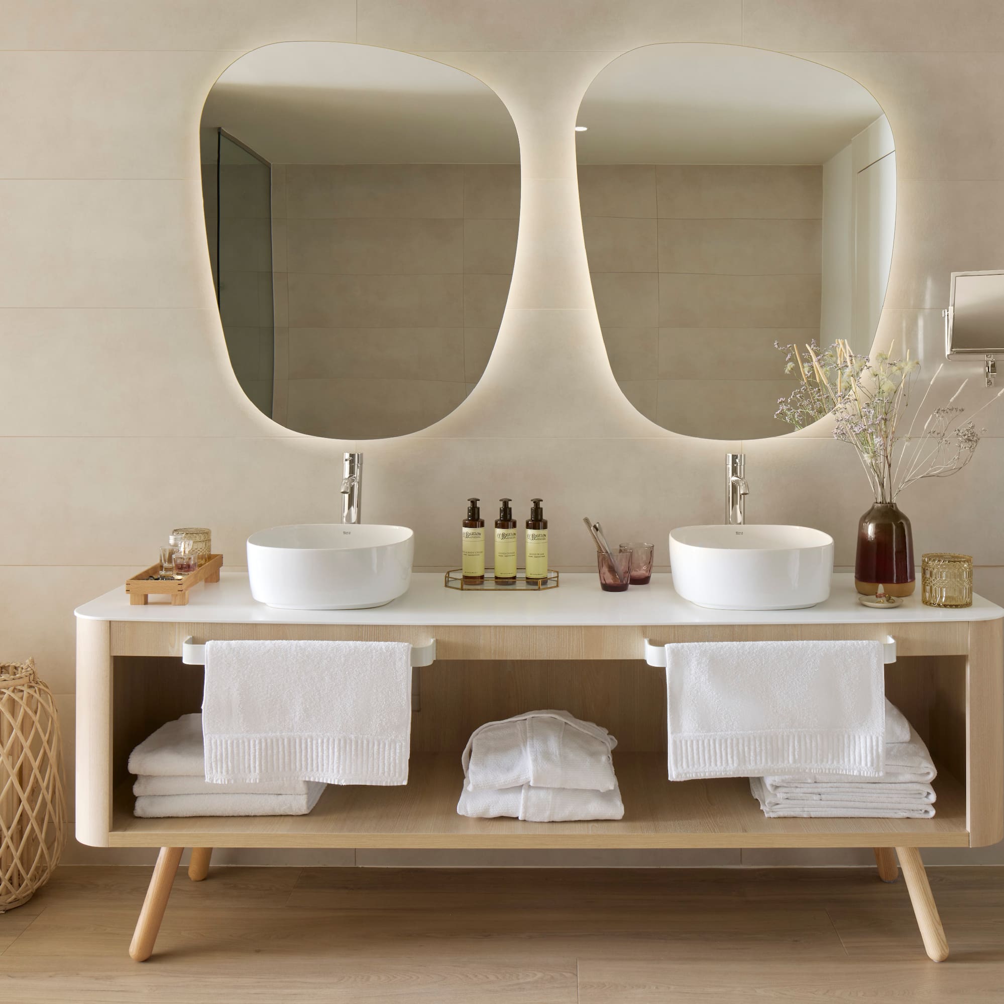 a bathroom with a double sink and mirrors