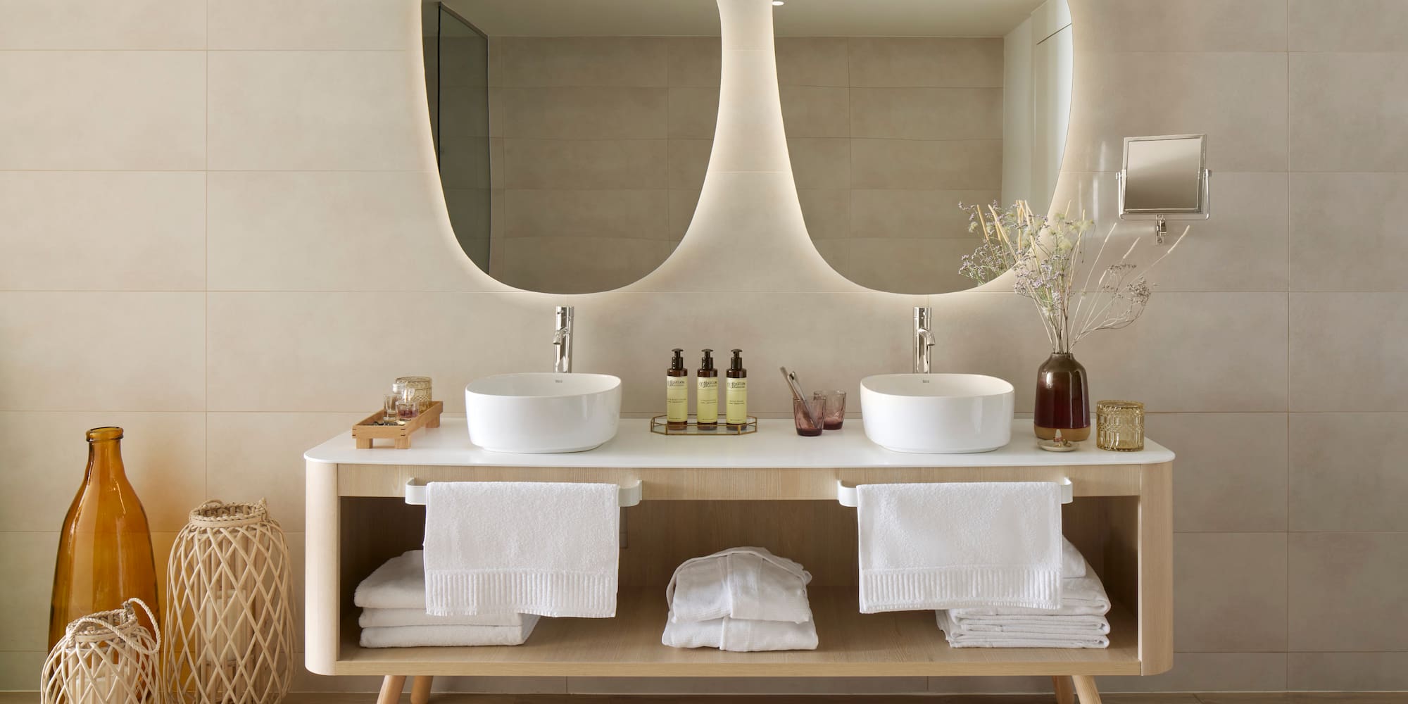 a bathroom with a double sink and mirrors