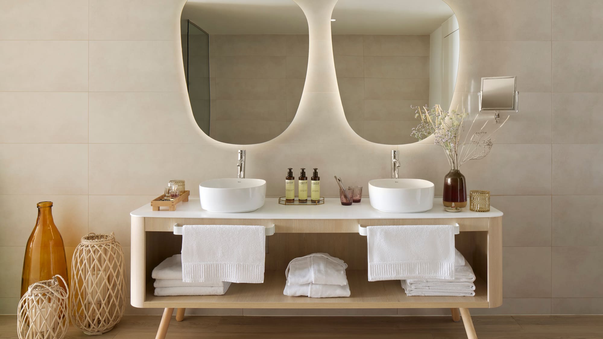a bathroom with a double sink and mirrors