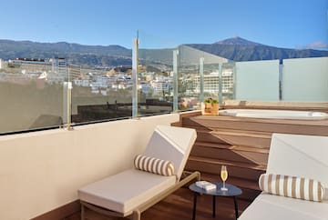 a deck with chairs and a table on it