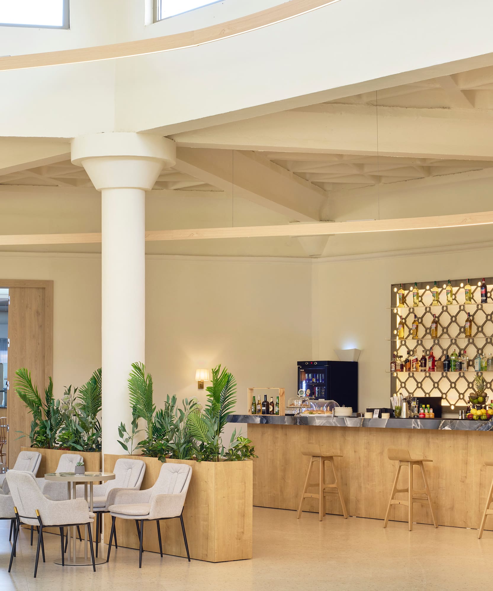 a room with a bar and chairs