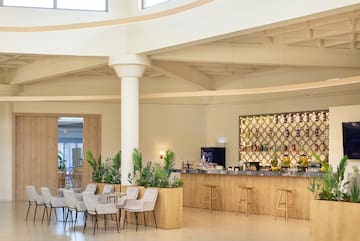 a room with a bar and chairs