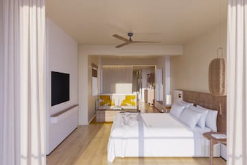 a room with a bed and a television