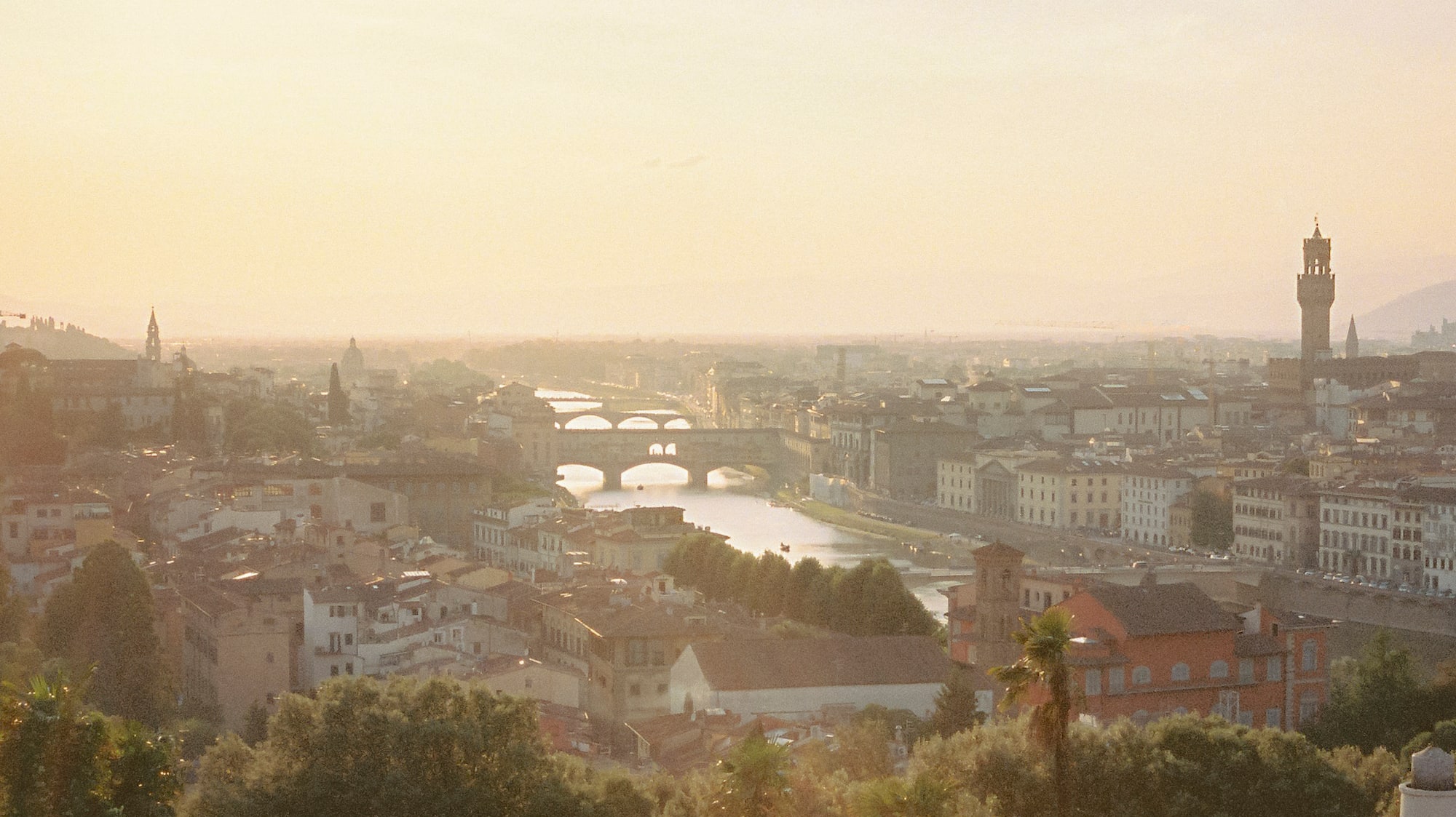 a group of people standing on a hill overlooking a city