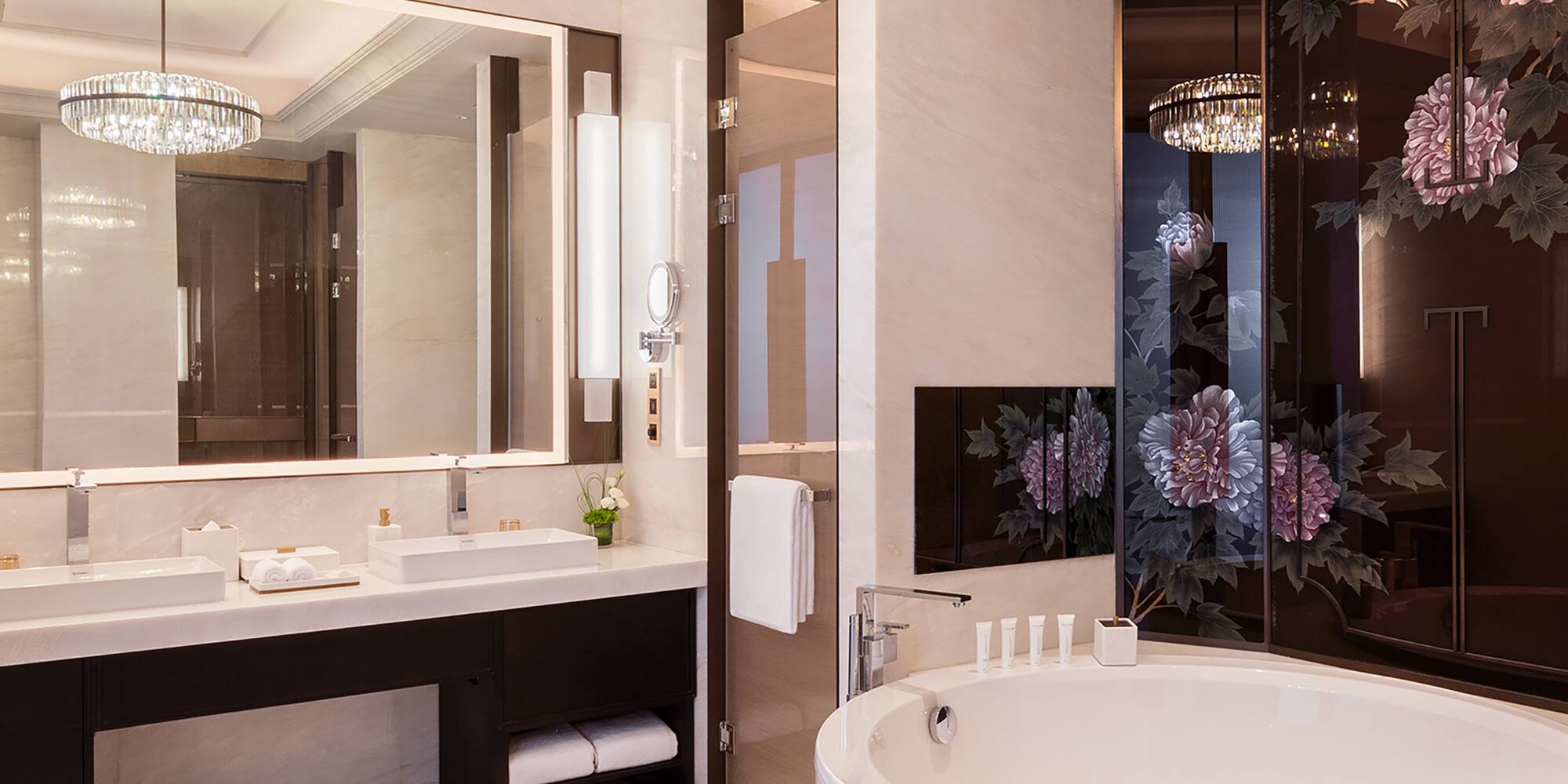 a bathroom with a large tub and a chandelier