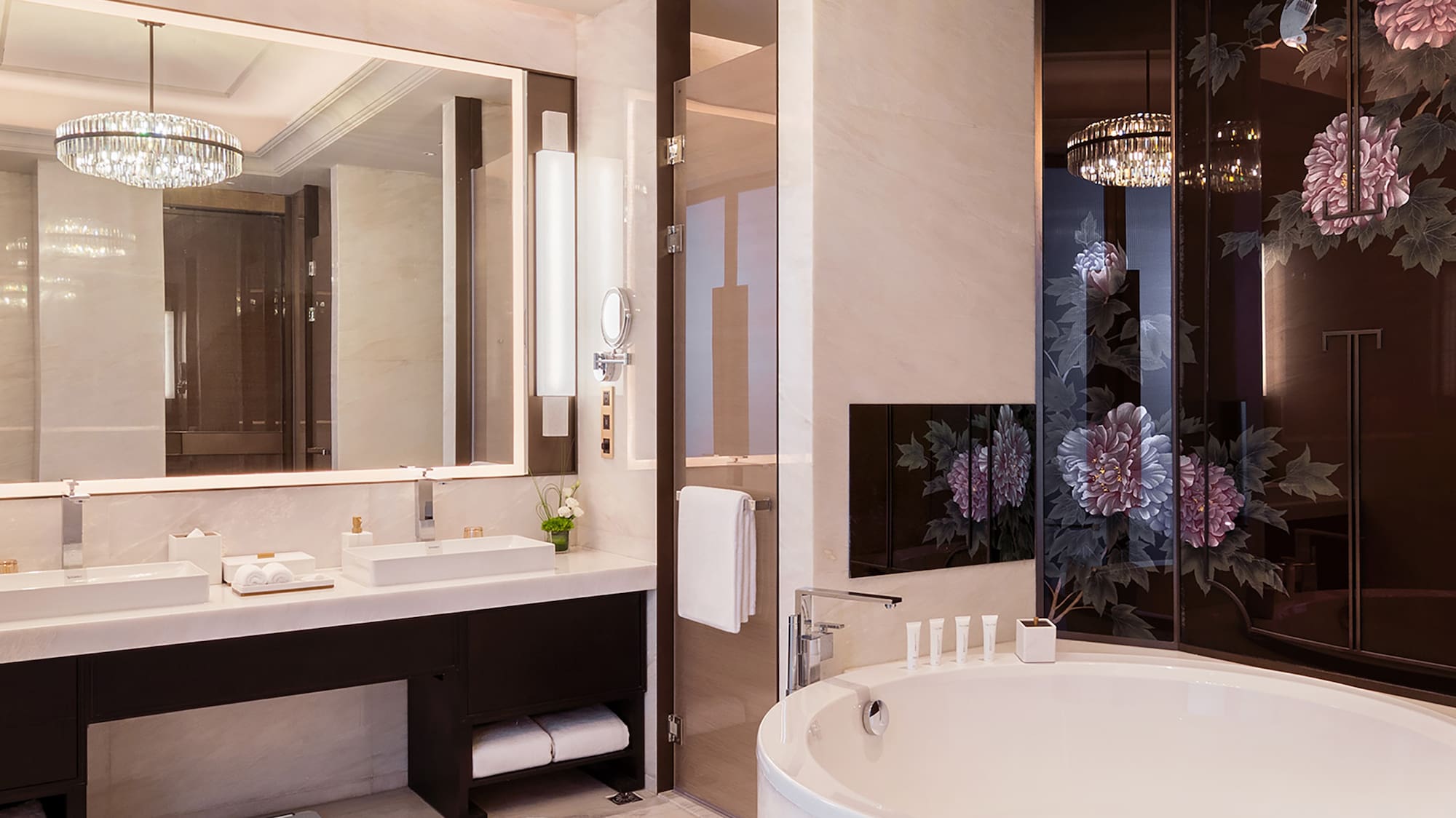 a bathroom with a large tub and a chandelier