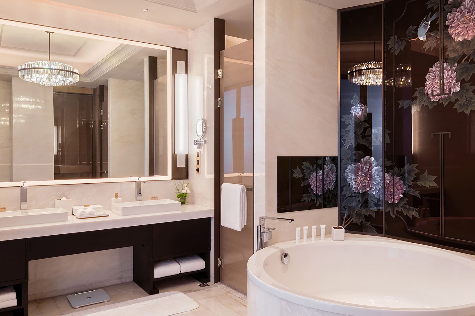a bathroom with a large tub and a chandelier