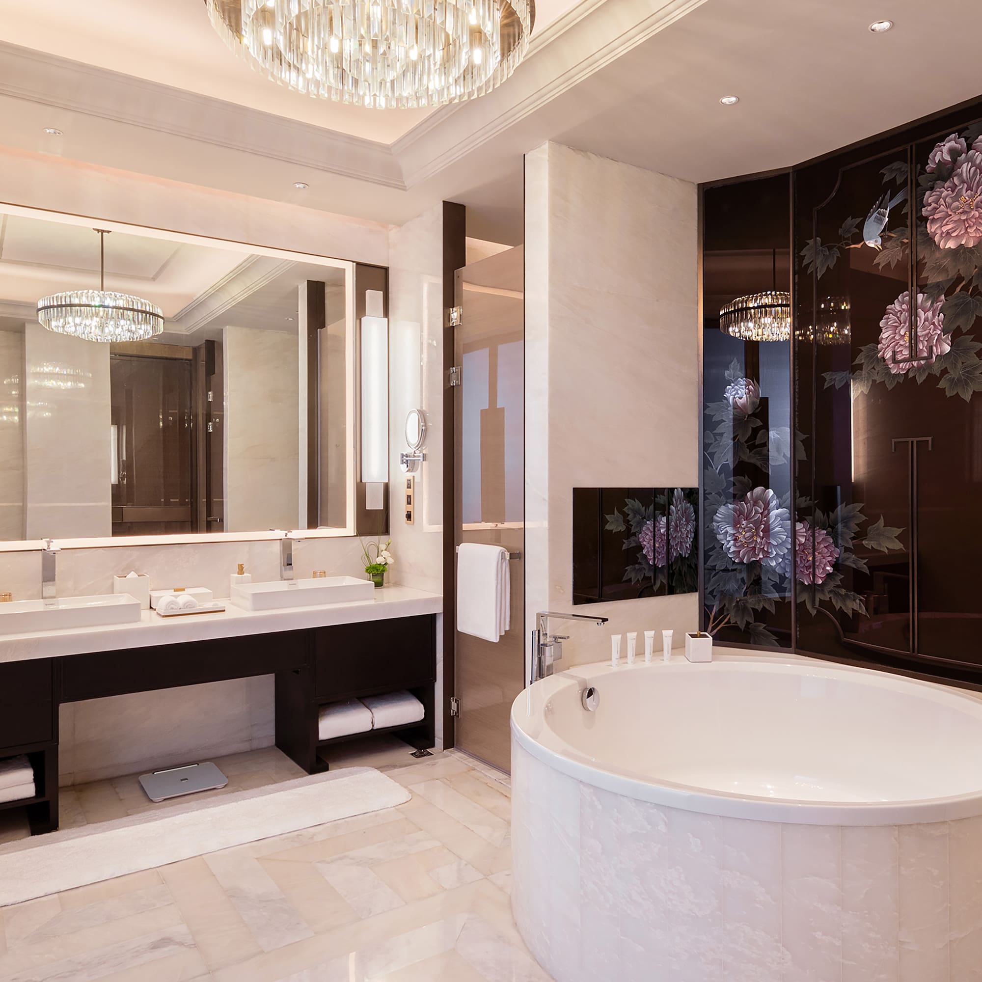 a bathroom with a large tub and a chandelier