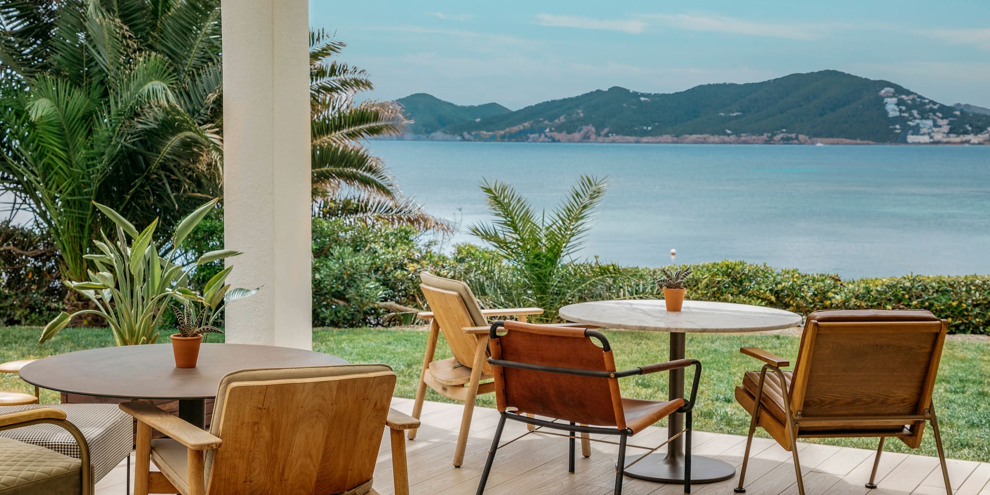 a table and chairs on a deck overlooking a body of water