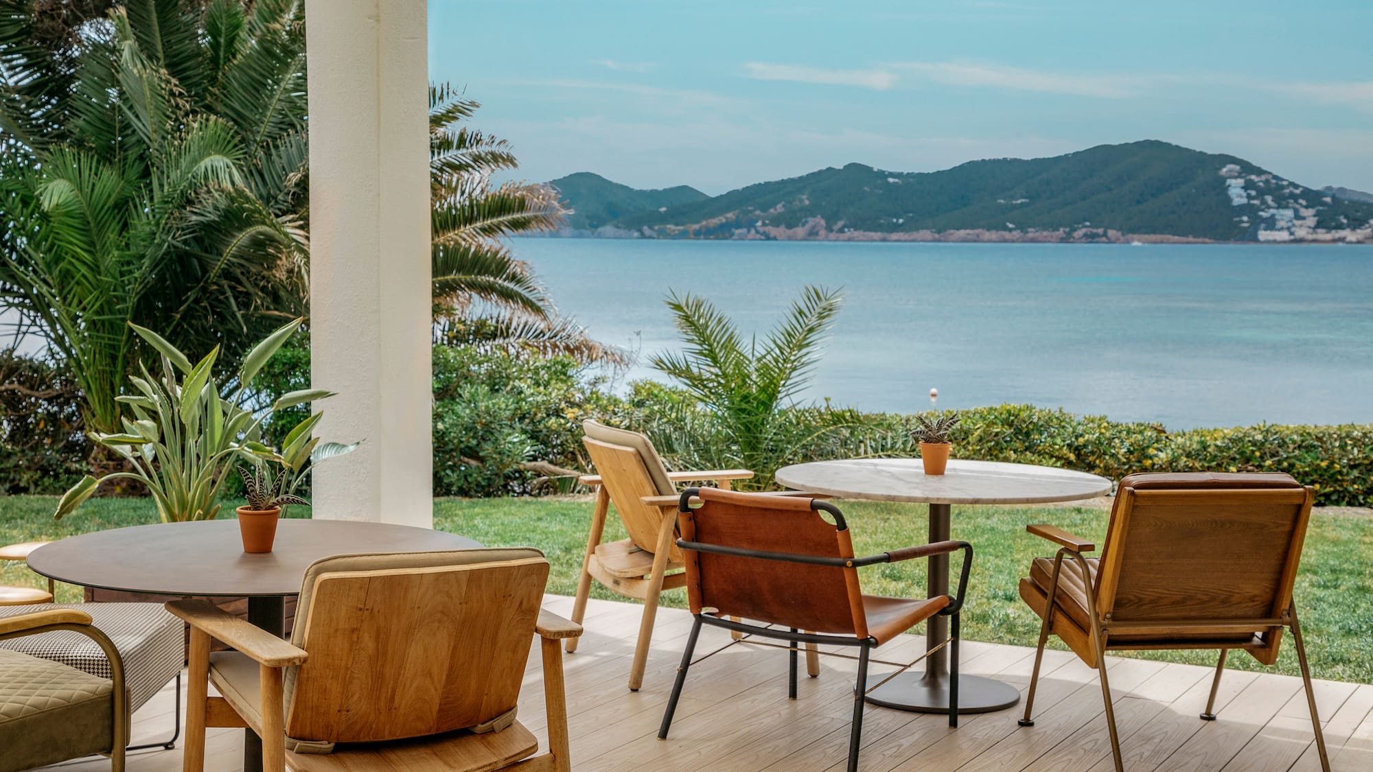 a table and chairs on a deck overlooking a body of water