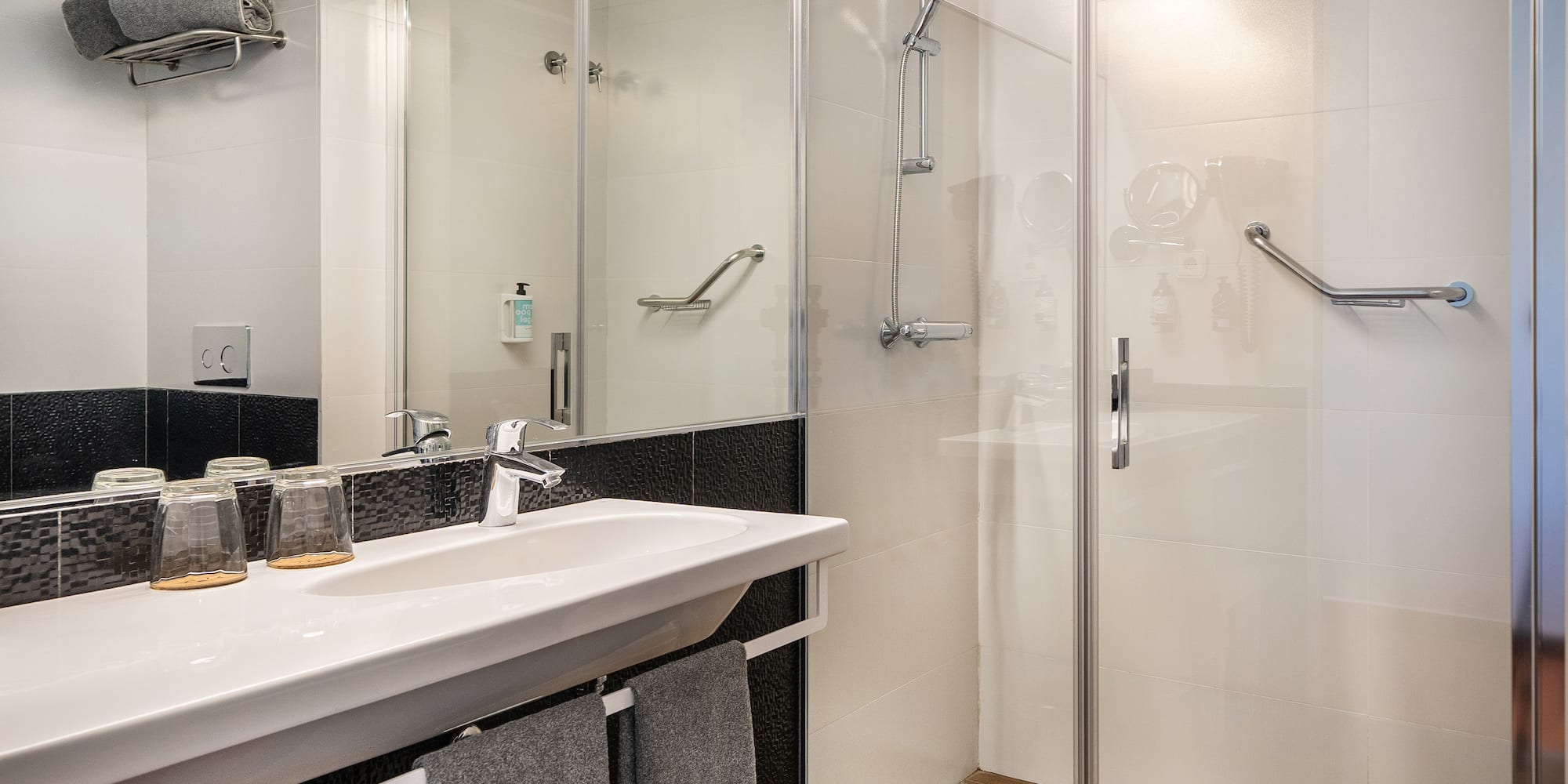 a bathroom with a shower and sink