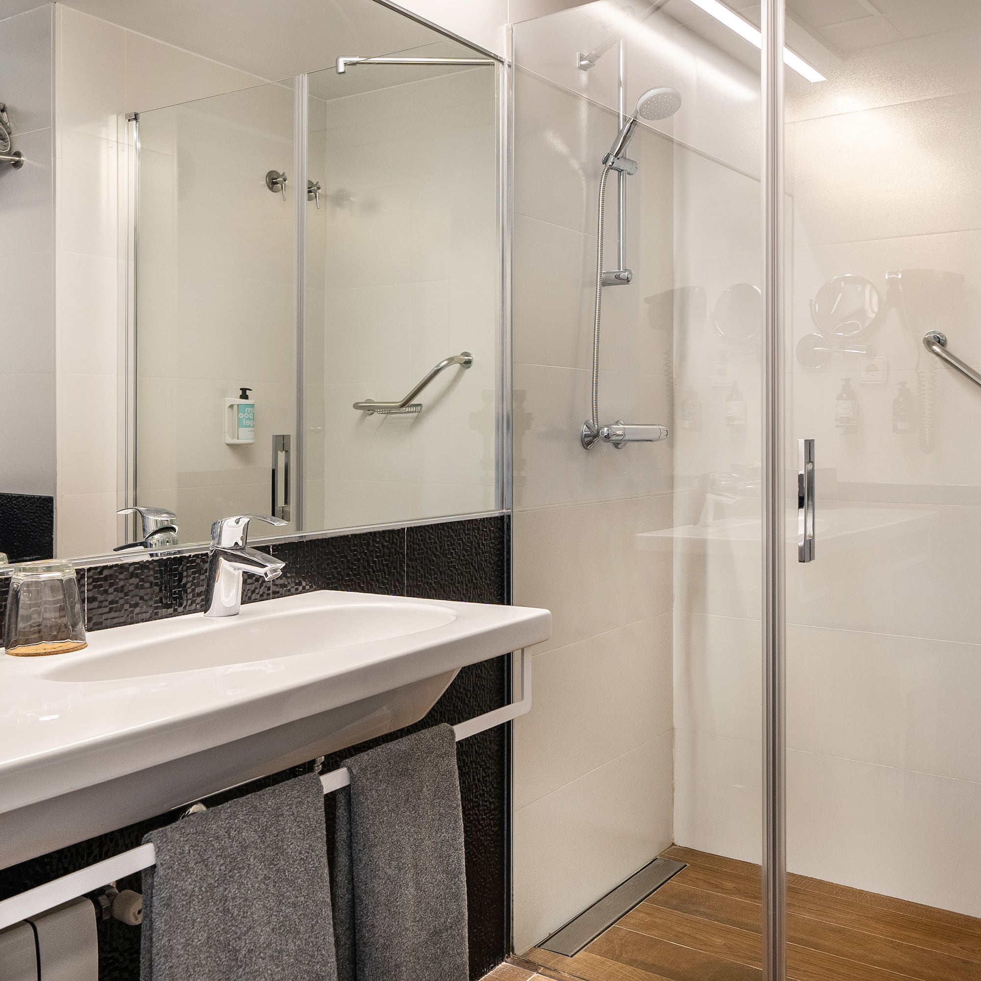 a bathroom with a shower and sink