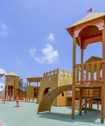 a playground with a structure on the ground