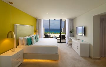 a bedroom with a large window overlooking the ocean