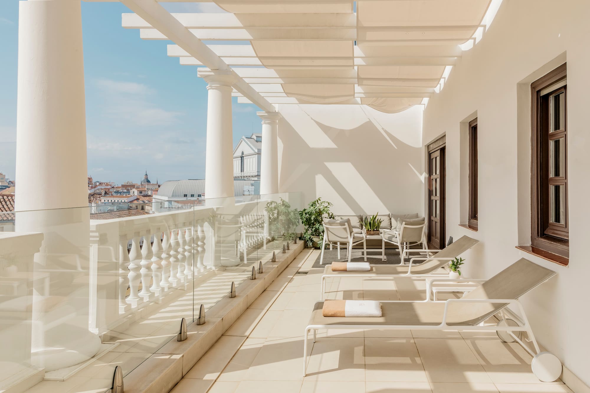 a patio with chairs and a white railing