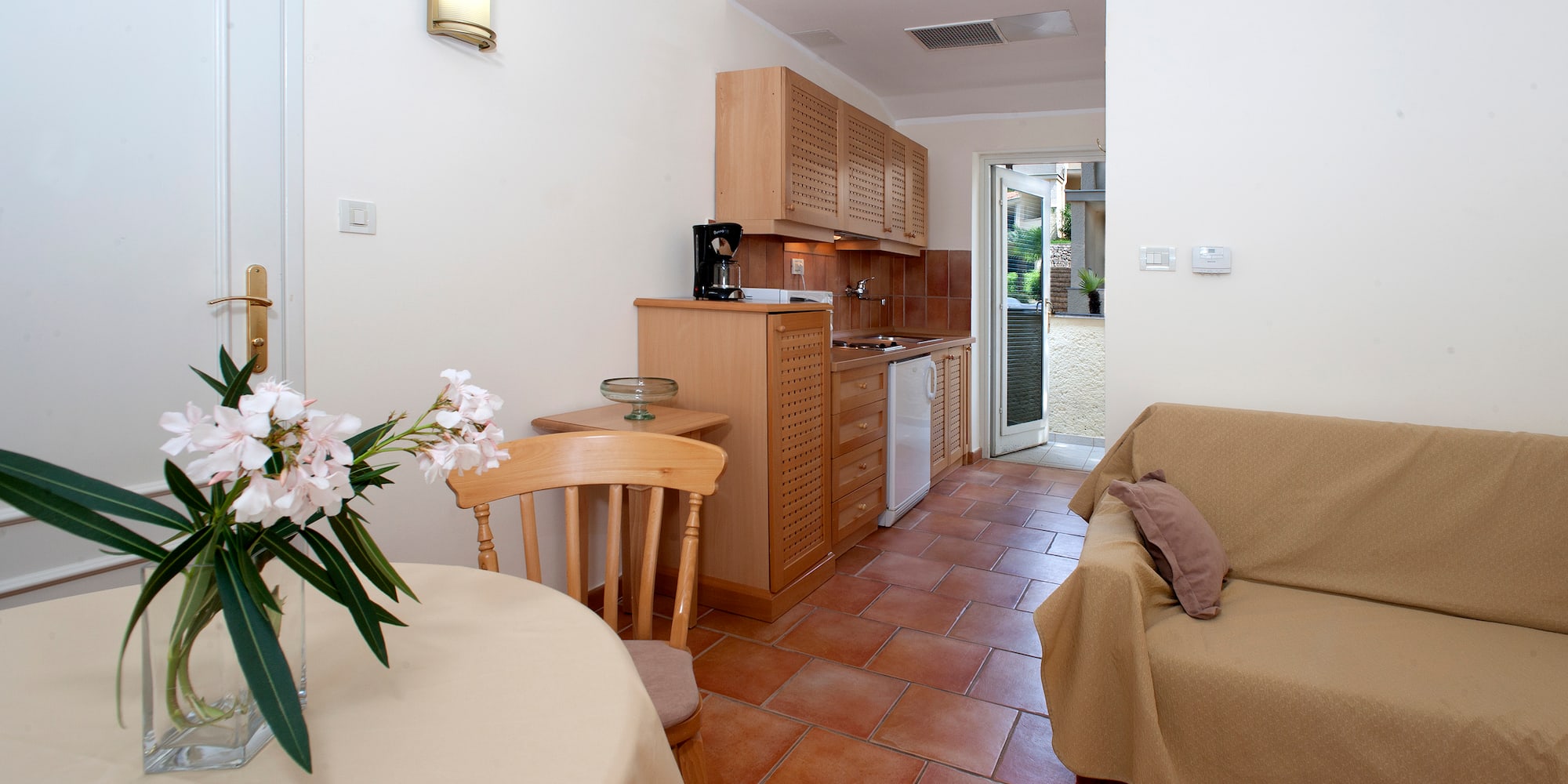 a living room with a couch and kitchen