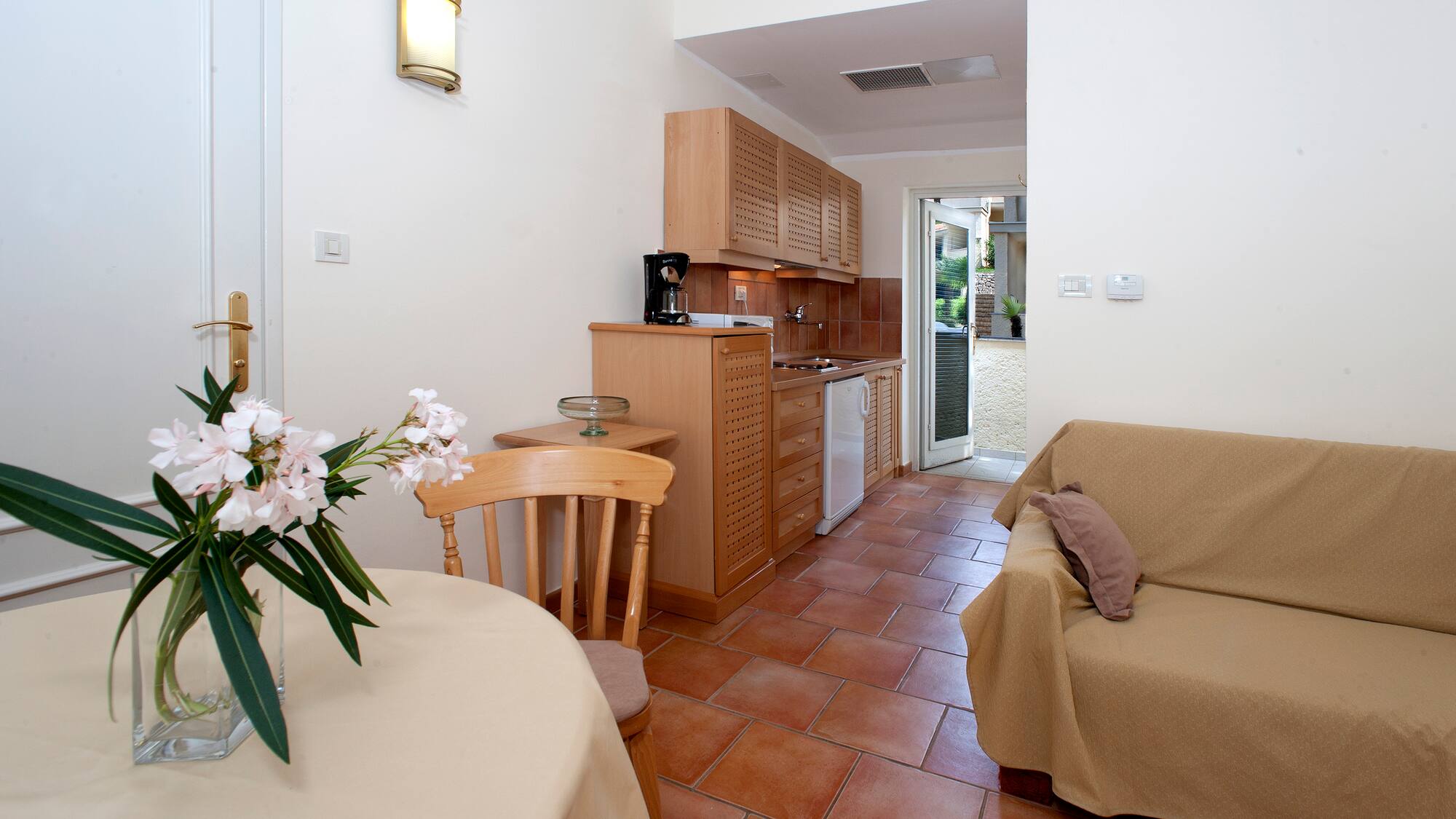 a living room with a couch and kitchen