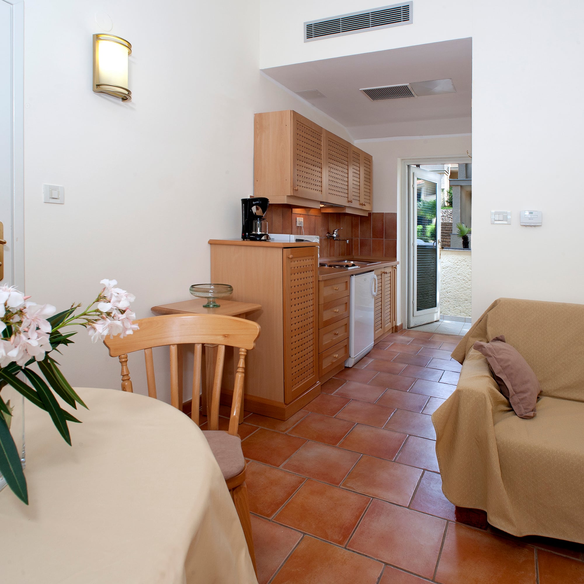 a living room with a couch and kitchen