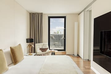 a bedroom with a bed and a chair