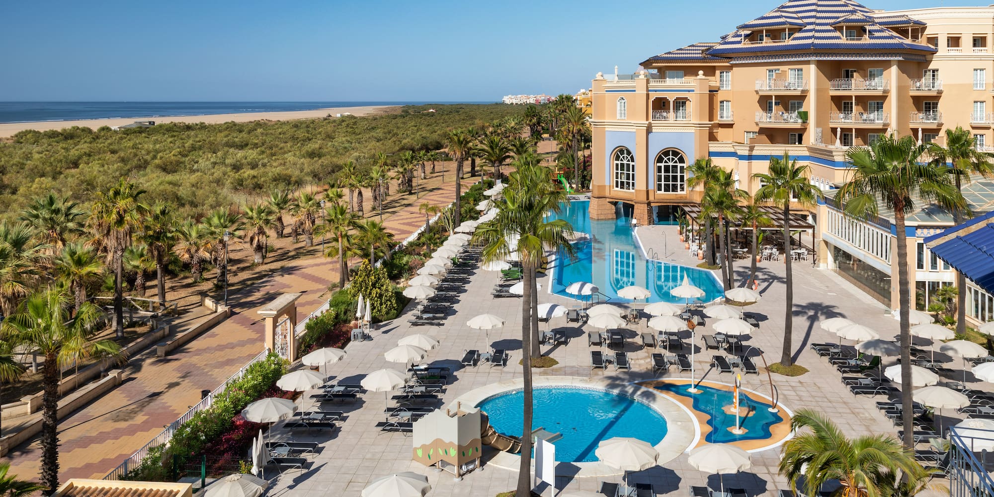 a pool and umbrellas in a hotel