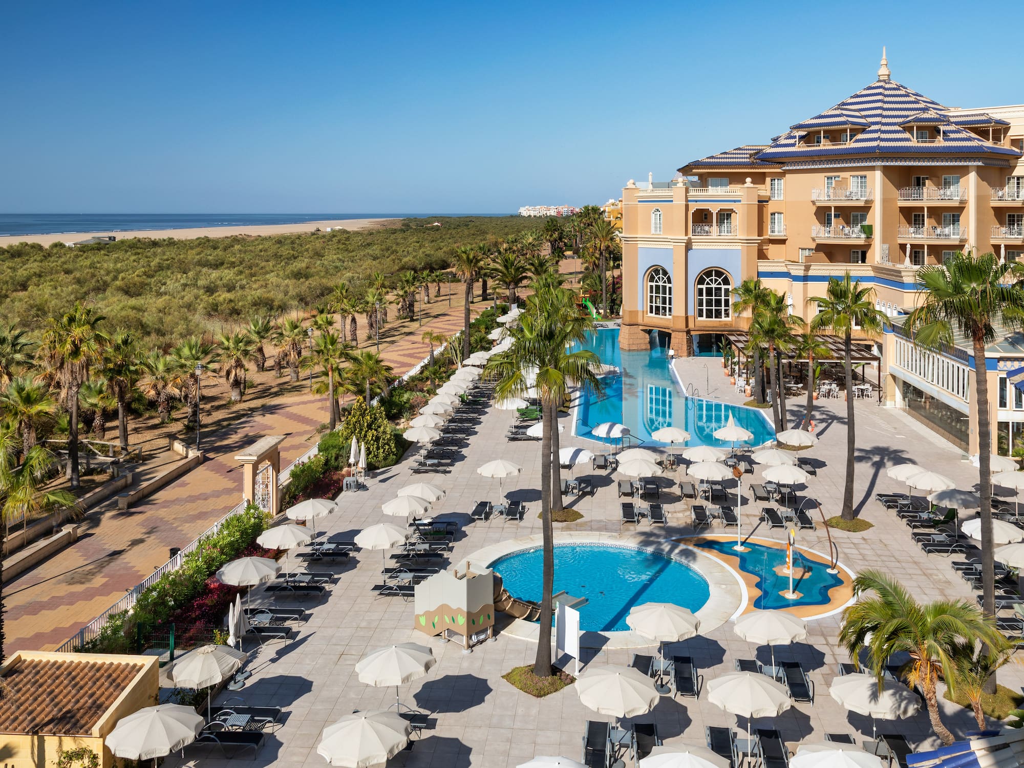 a pool and umbrellas in a hotel