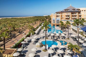 a pool and umbrellas in a hotel
