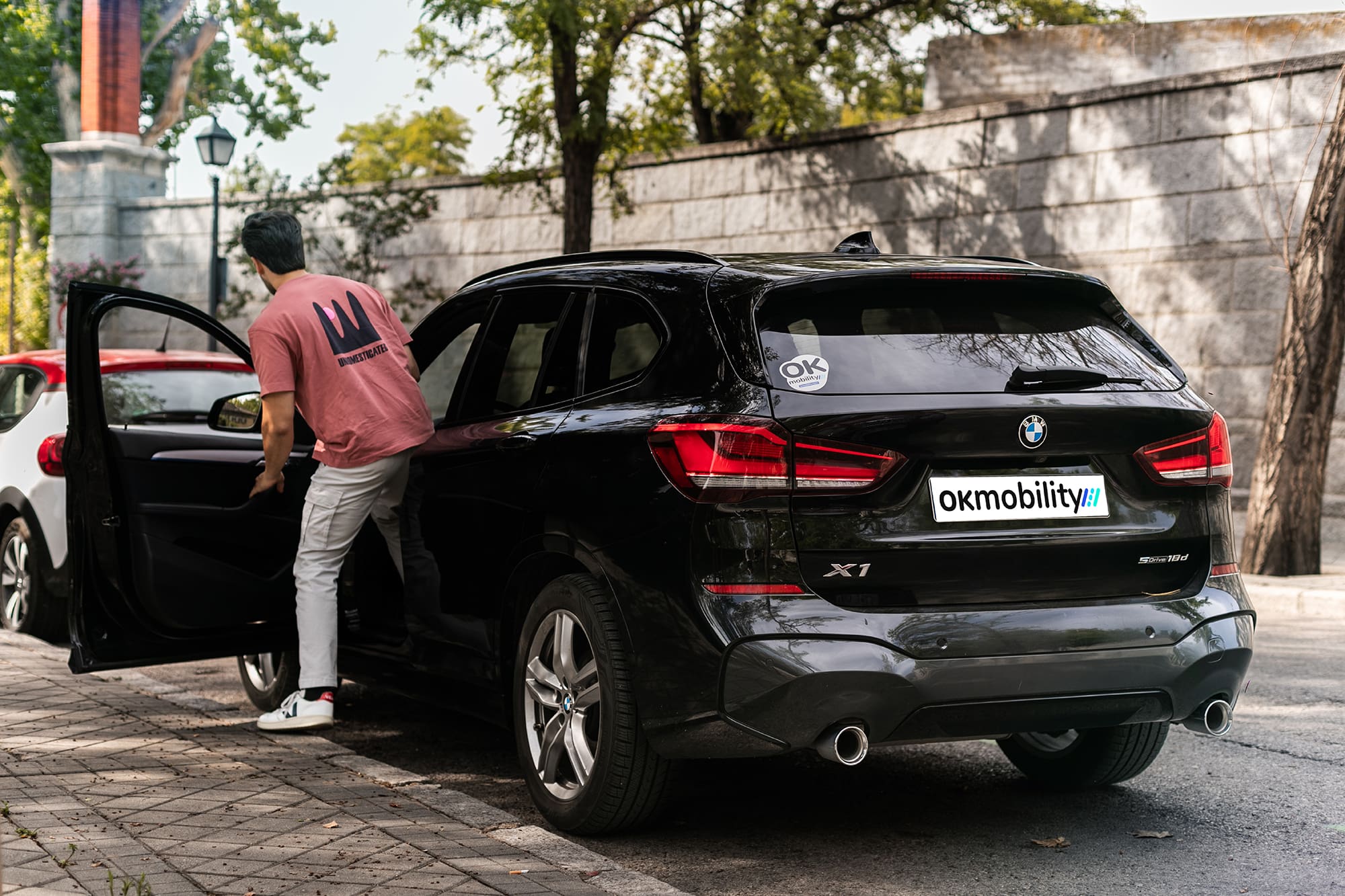 a man climbing into a car