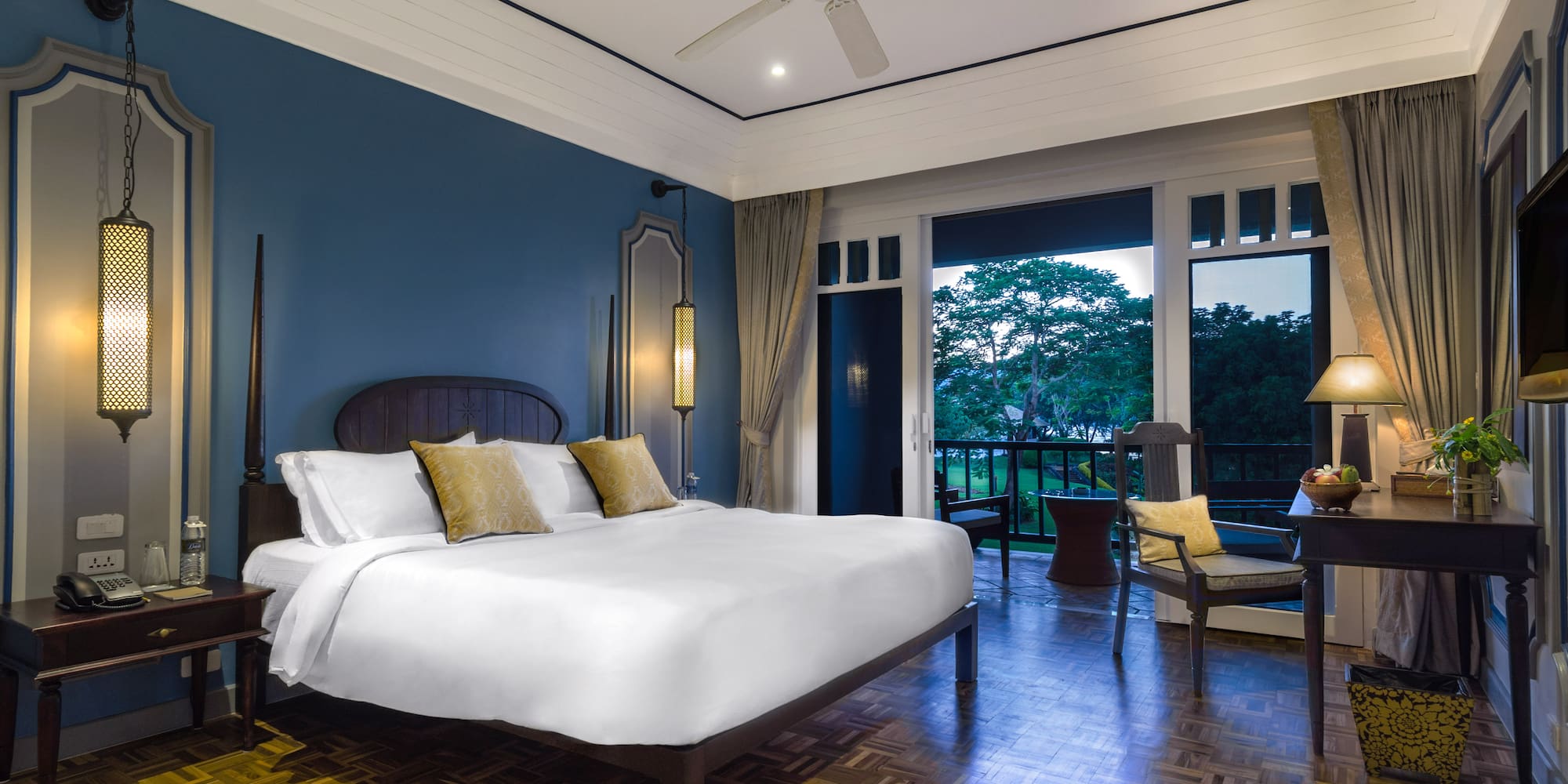 a bedroom with a large bed and a ceiling fan