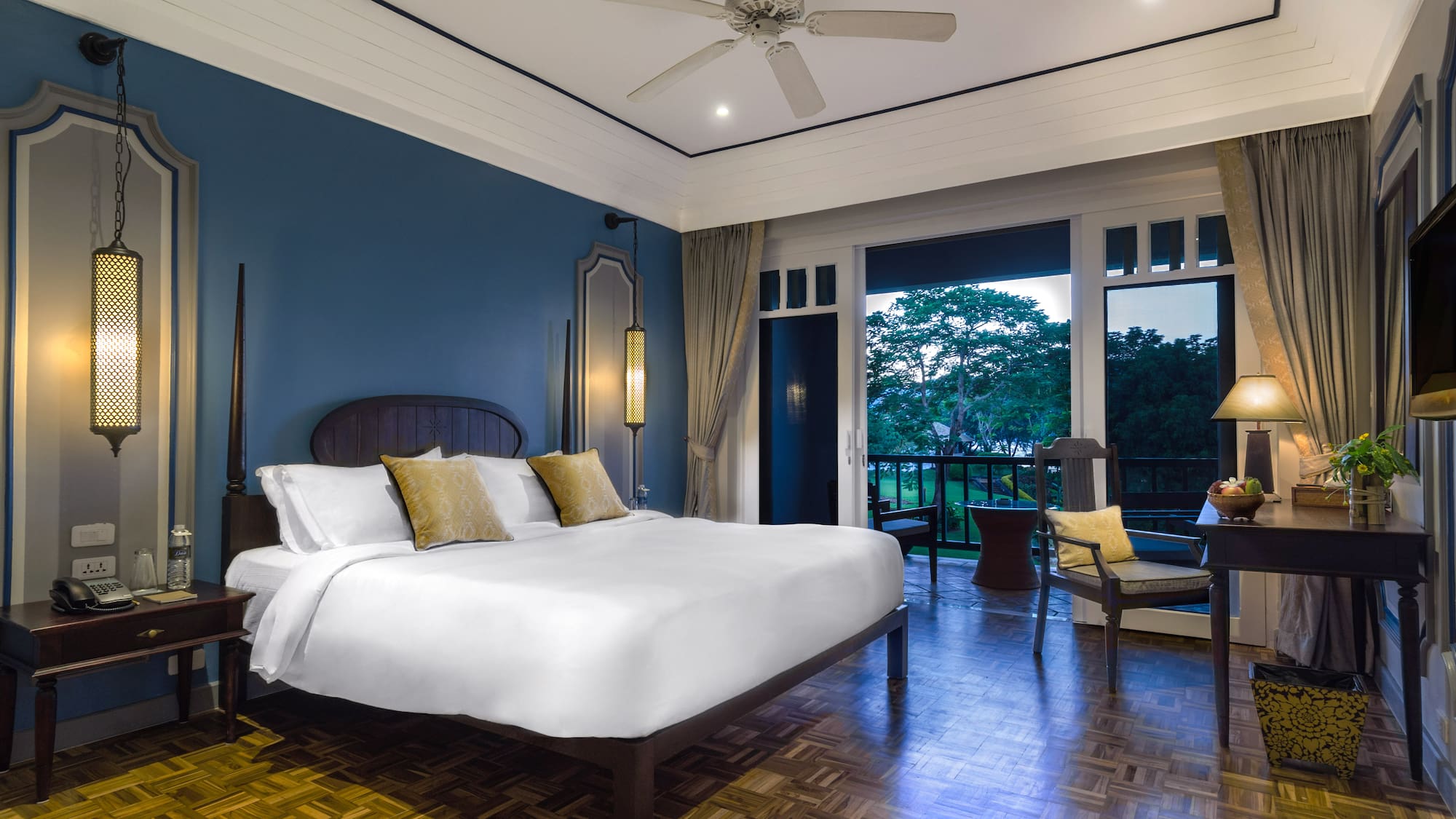 a bedroom with a large bed and a ceiling fan