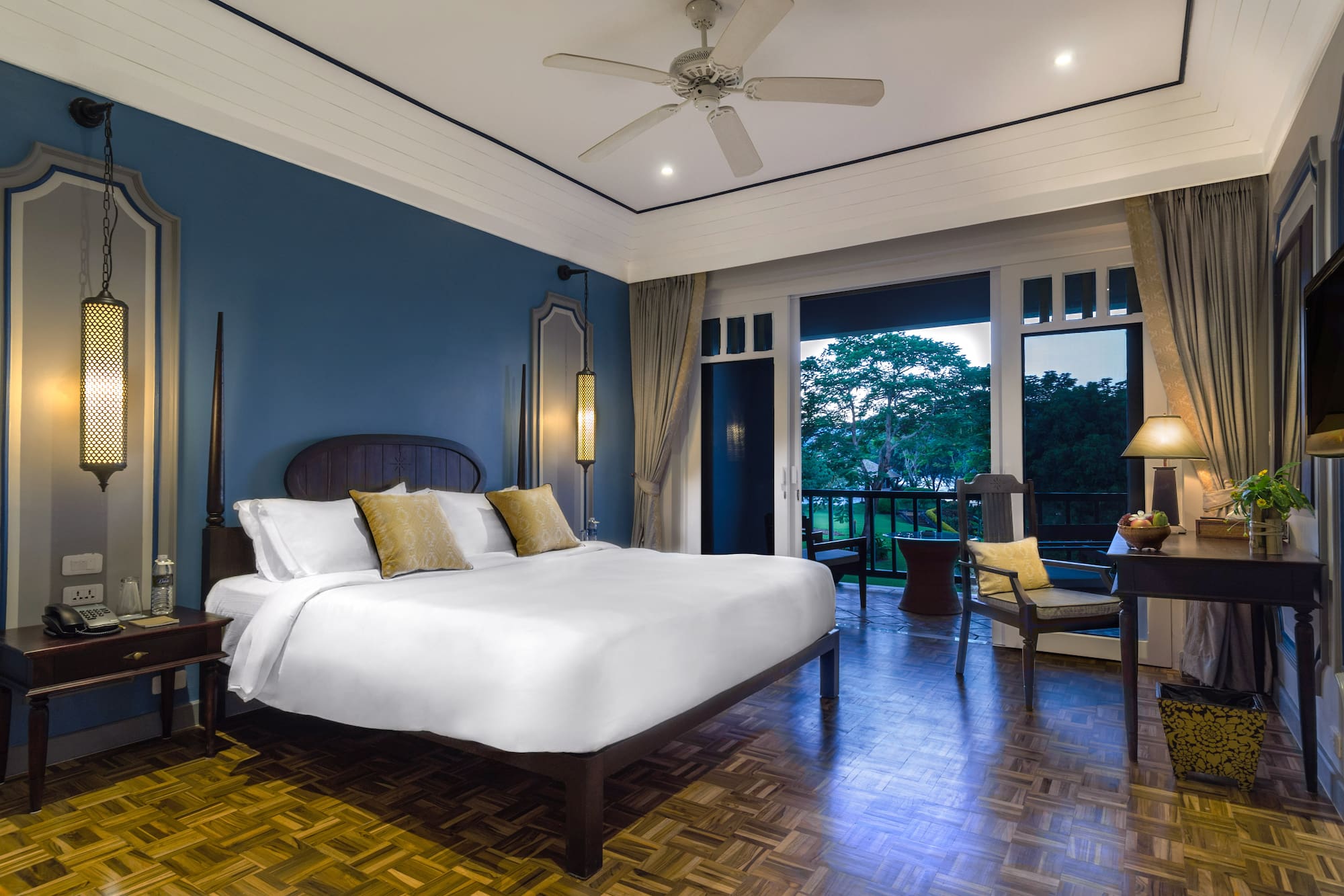 a bedroom with a large bed and a ceiling fan