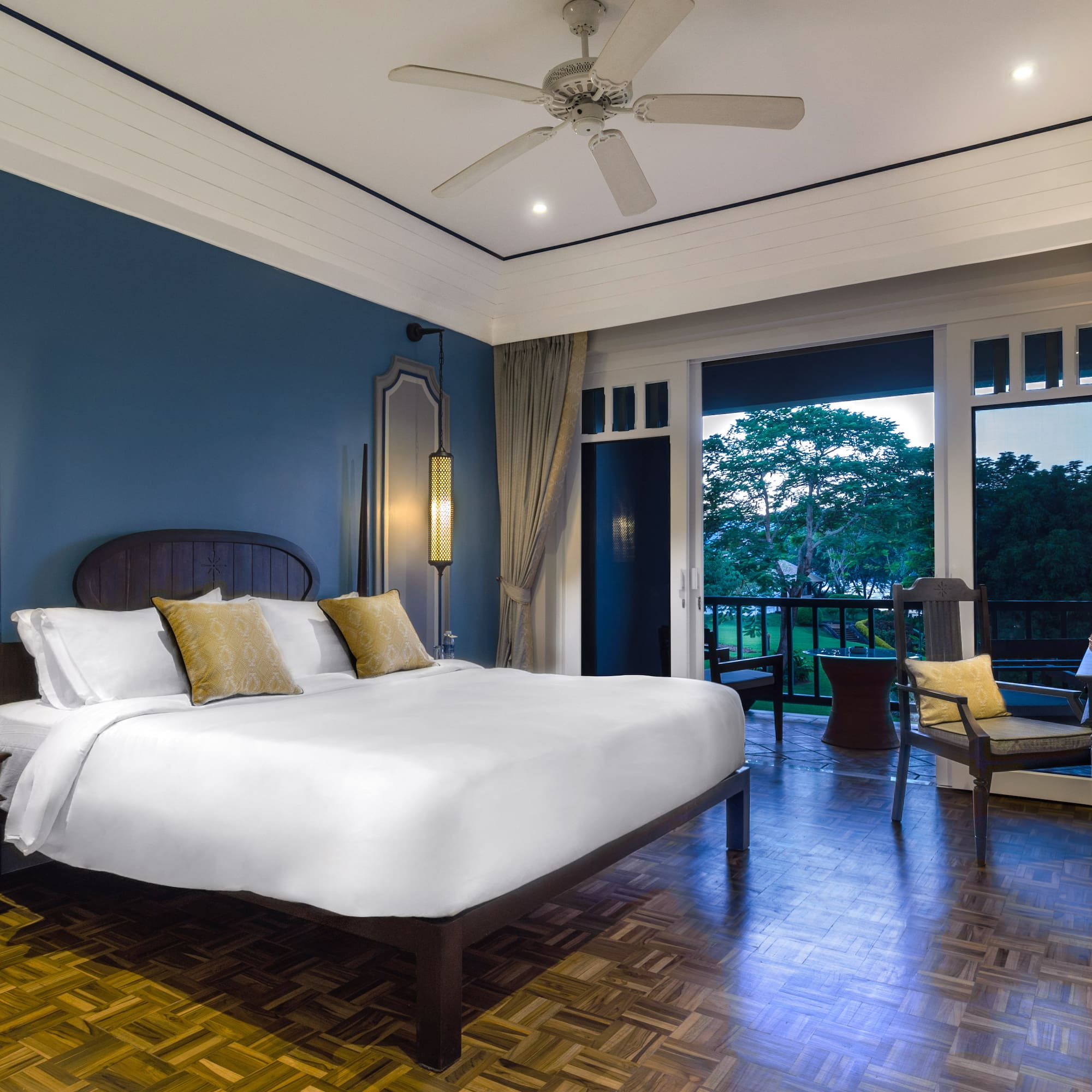 a bedroom with a large bed and a ceiling fan