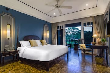 a bedroom with a large bed and a ceiling fan