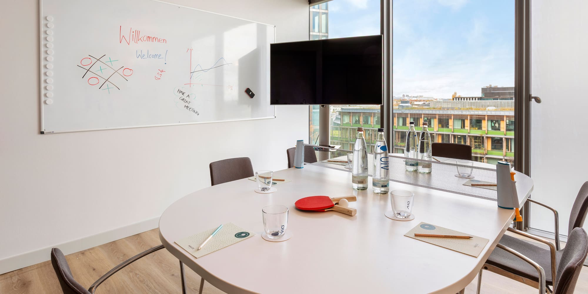 a table with a white board and a window