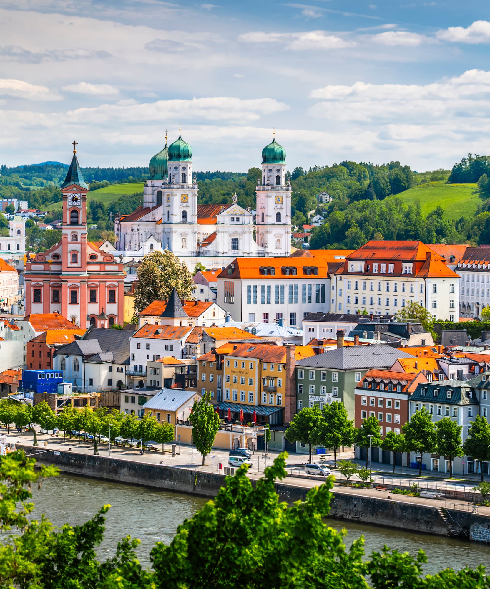 Passau, Germany, historic city with river, colorful buildings, and cathedral.