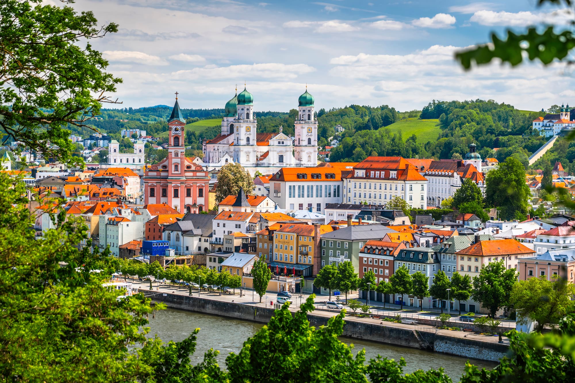 Passau, Germany, historic city with river, colorful buildings, and cathedral.