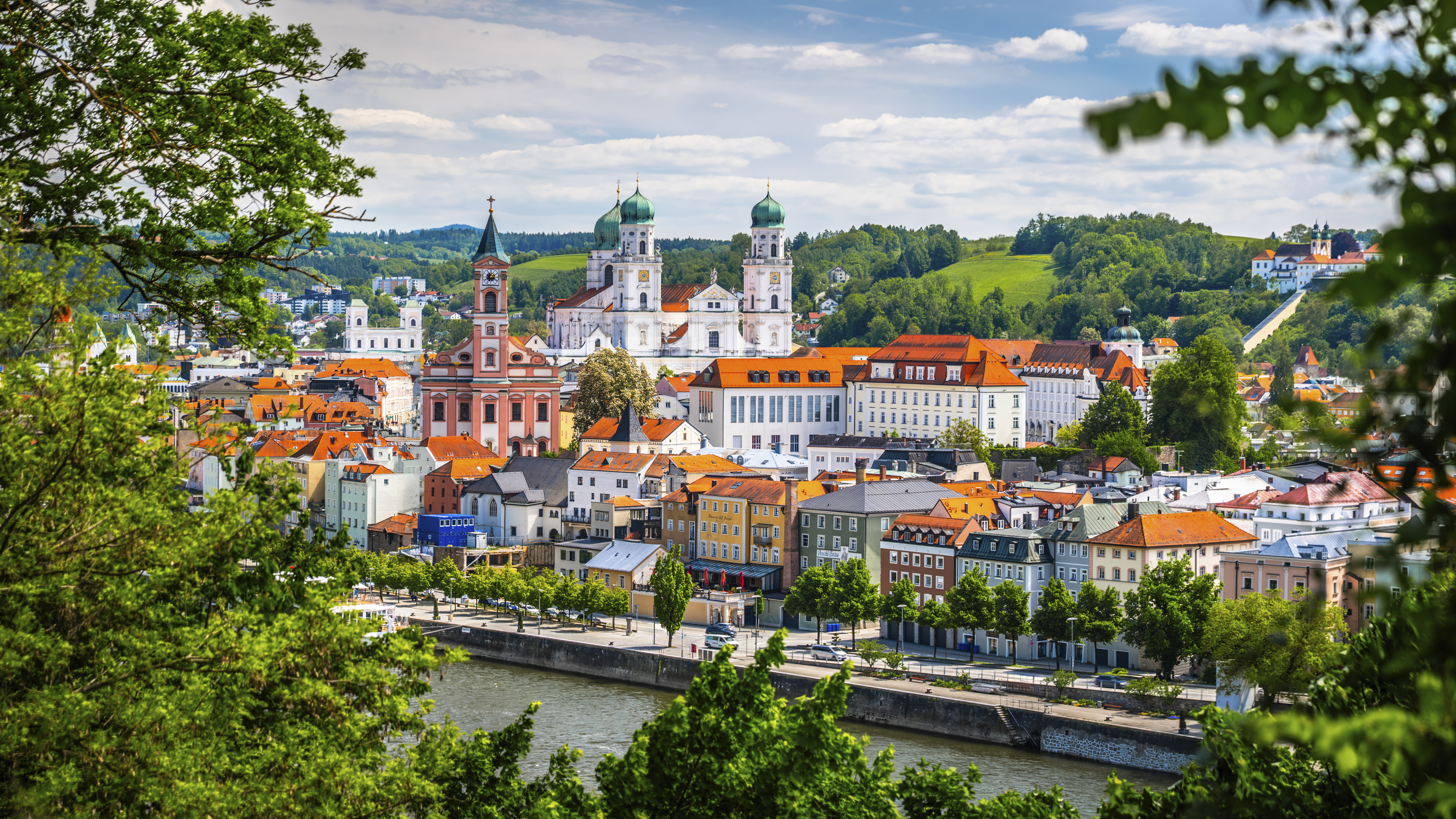 Passau, Germany, historic city with river, colorful buildings, and cathedral.