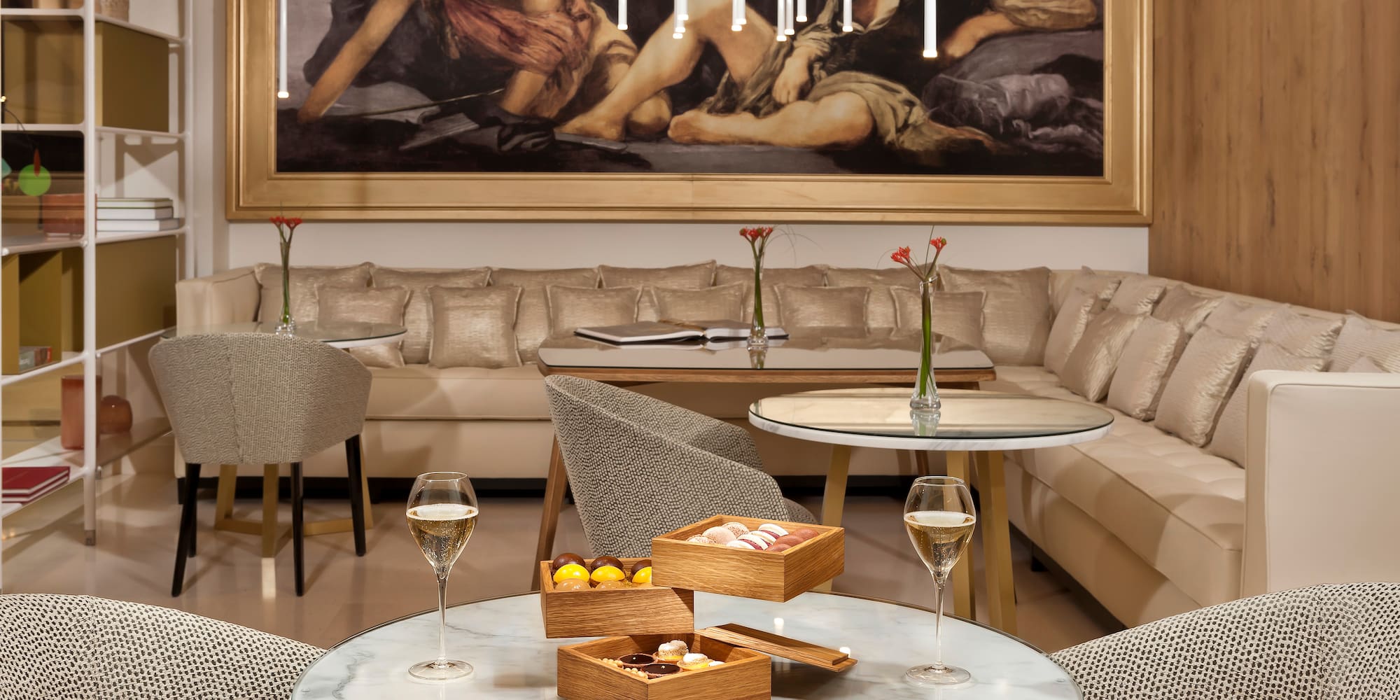 a room with a couch and a painting on the wall